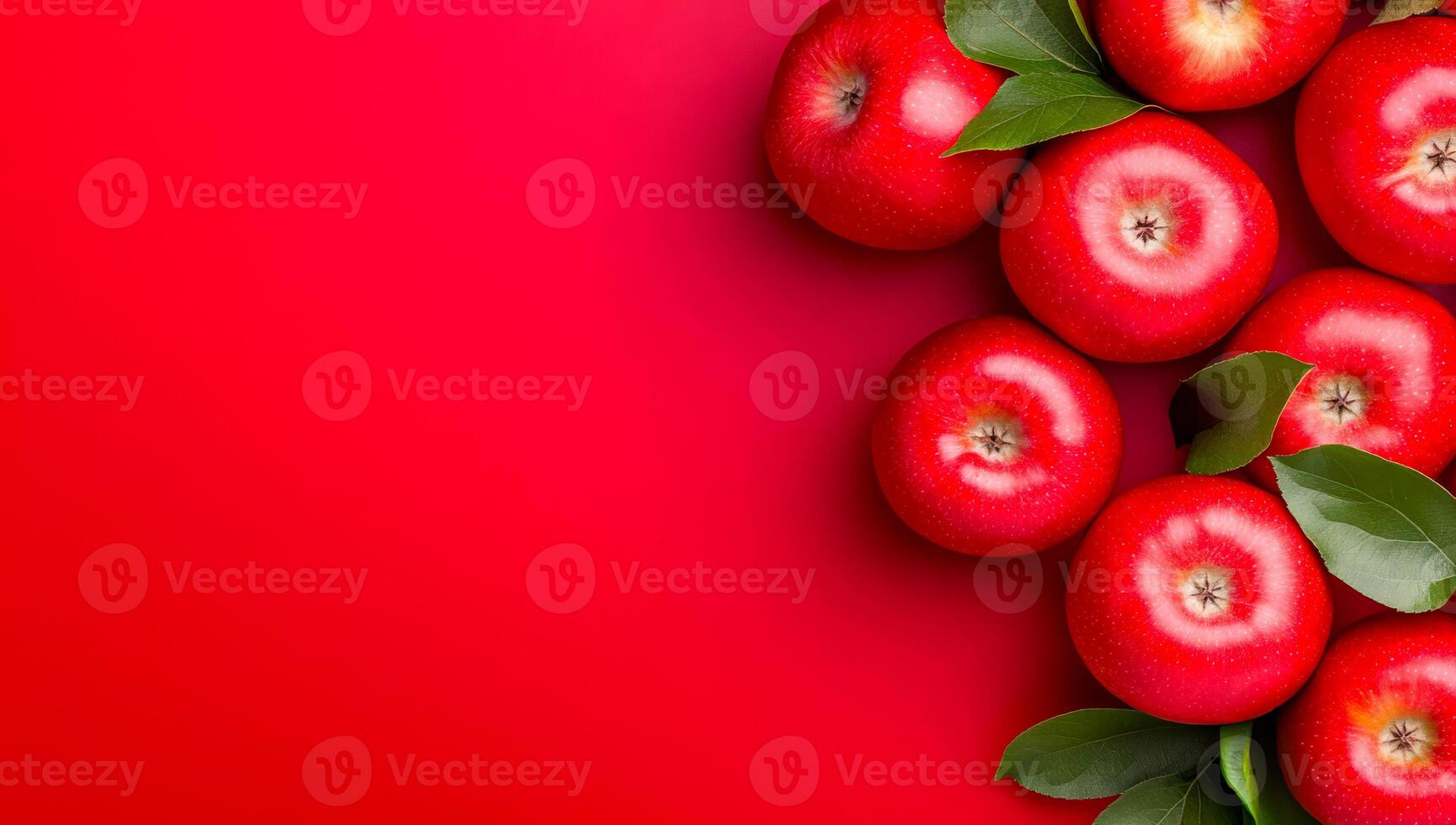 Fresh red apples on a vibrant background. Bright red apples with green leaves arranged against a striking red backdrop create an appealing visual display. photo