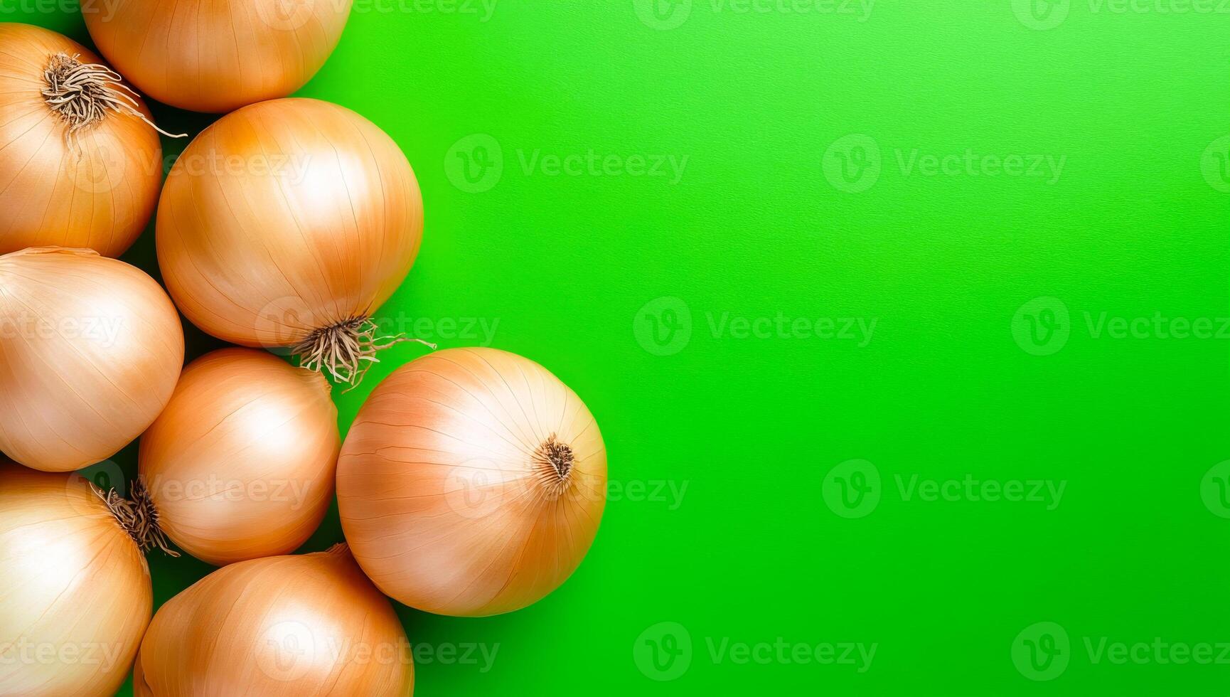 Fresh brown onions on green. Several brown onions rest on a vibrant green surface showcasing their smooth skin and natural textures. photo