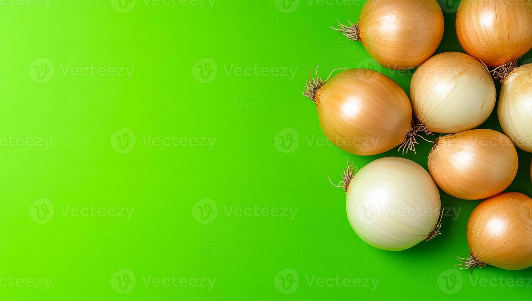 Fresh onions on bright green surface. Various types of onions arranged on a vibrant green background, showcasing their different sizes and shapes. photo