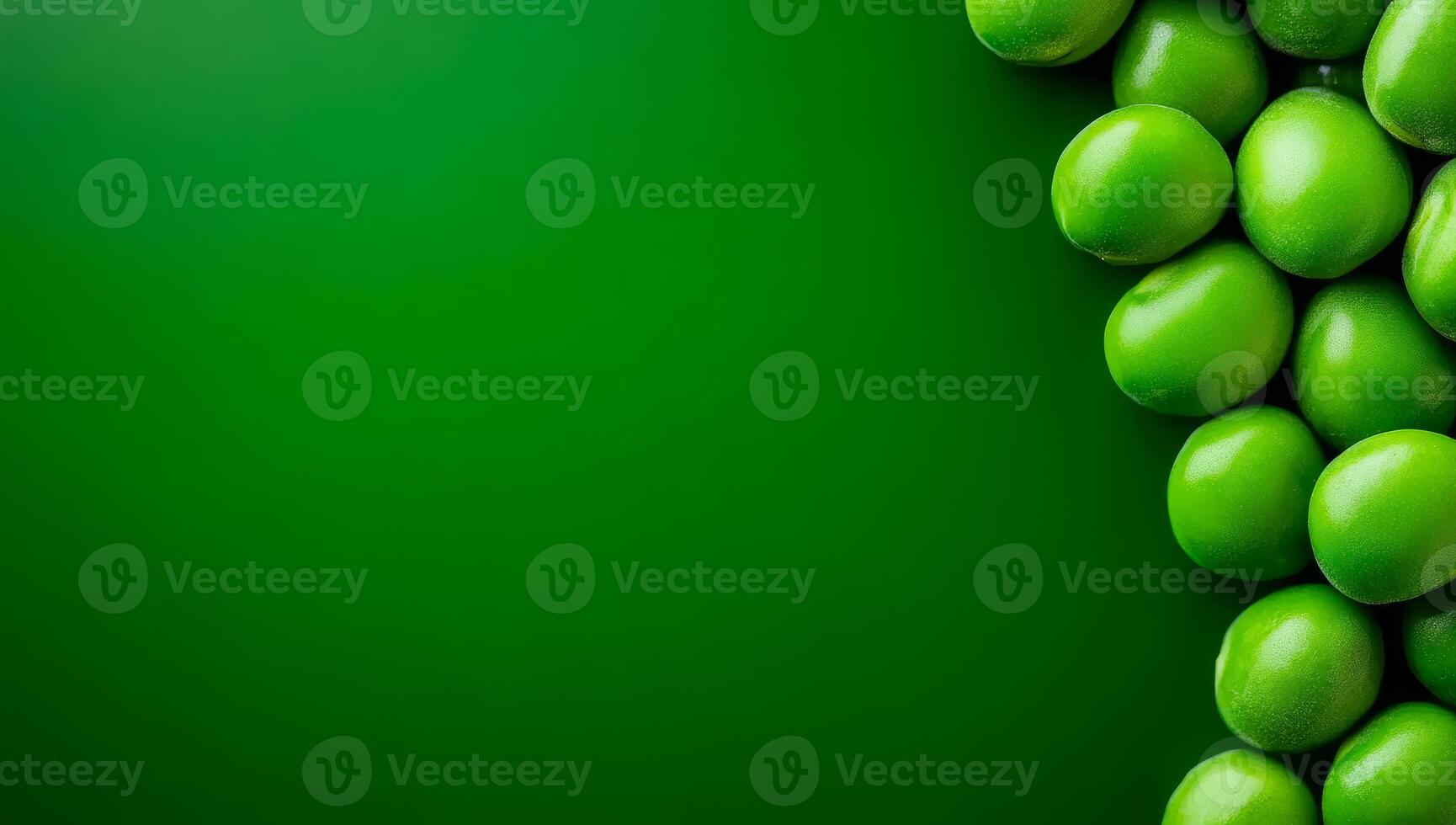 Green olives on a bright BG. Plump green olives cluster together against a rich green backdrop, highlighting their fresh appearance and color. photo