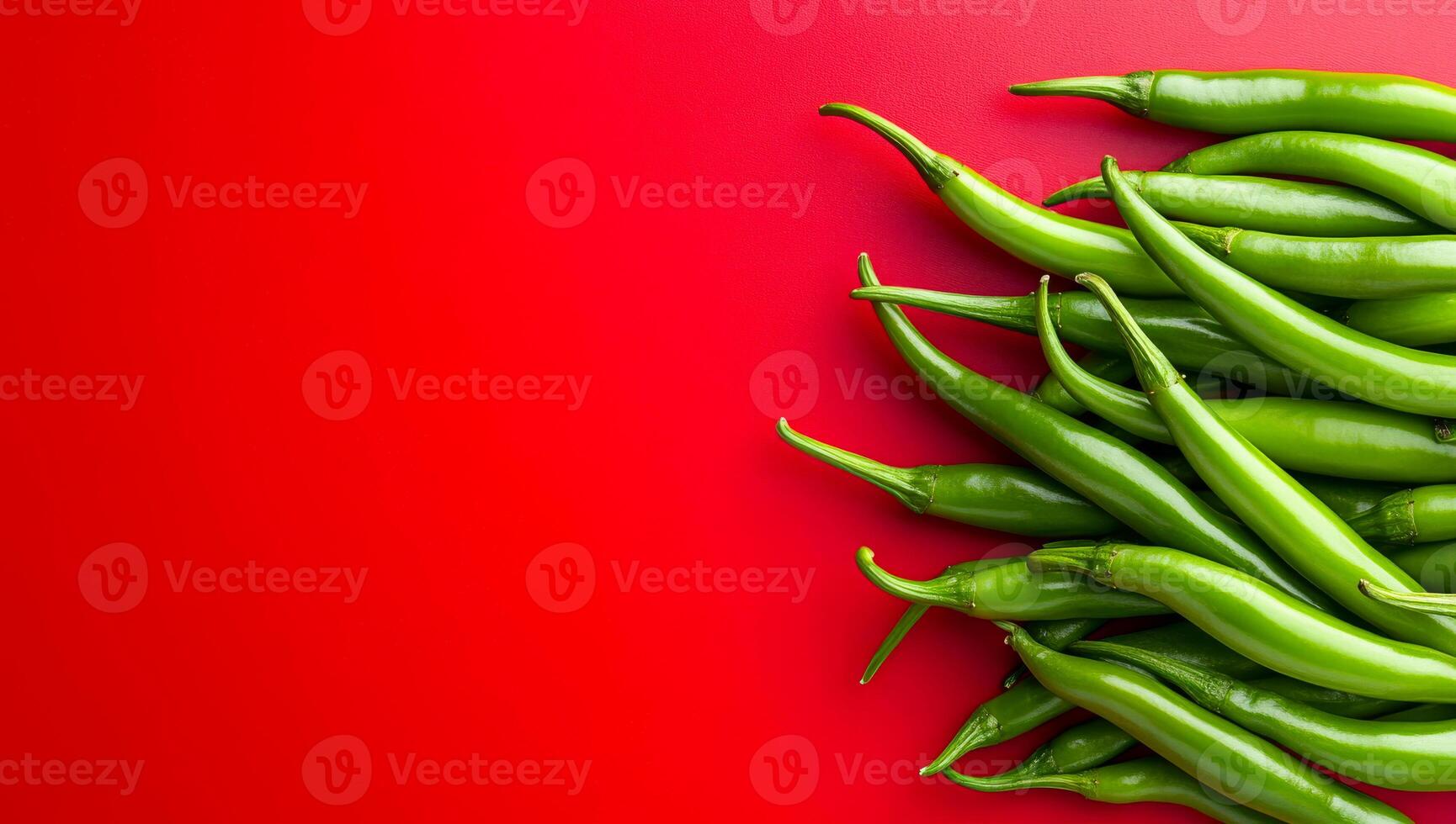 Green chili peppers on red background. Fresh green chili peppers are arranged on a bright red surface, showcasing their vibrant color and freshness. photo