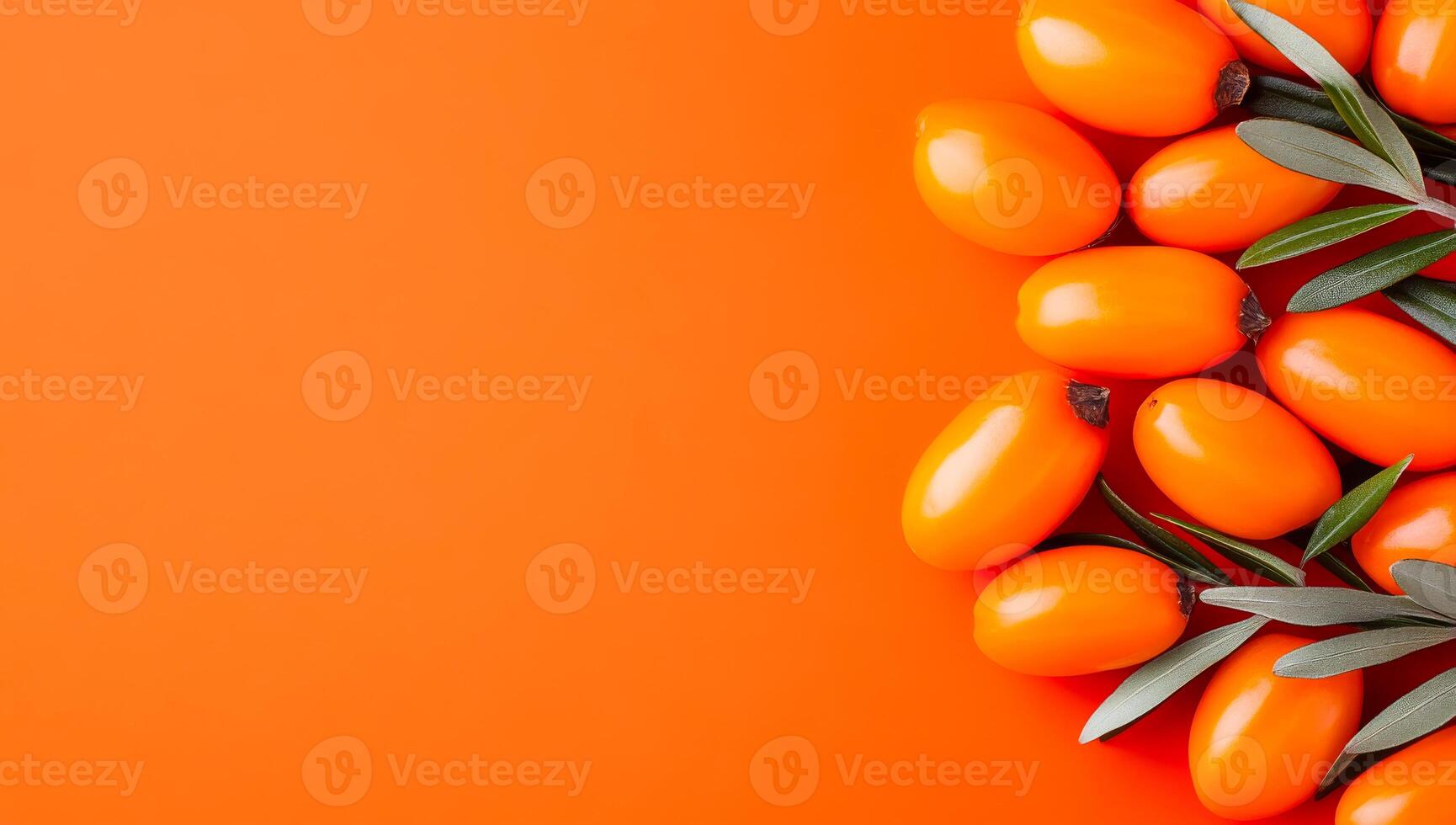 Sea buckthorn with green leaves. Fresh Sea buckthorn arranged beautifully with green leaves on a vibrant orange background creating a lively display. photo