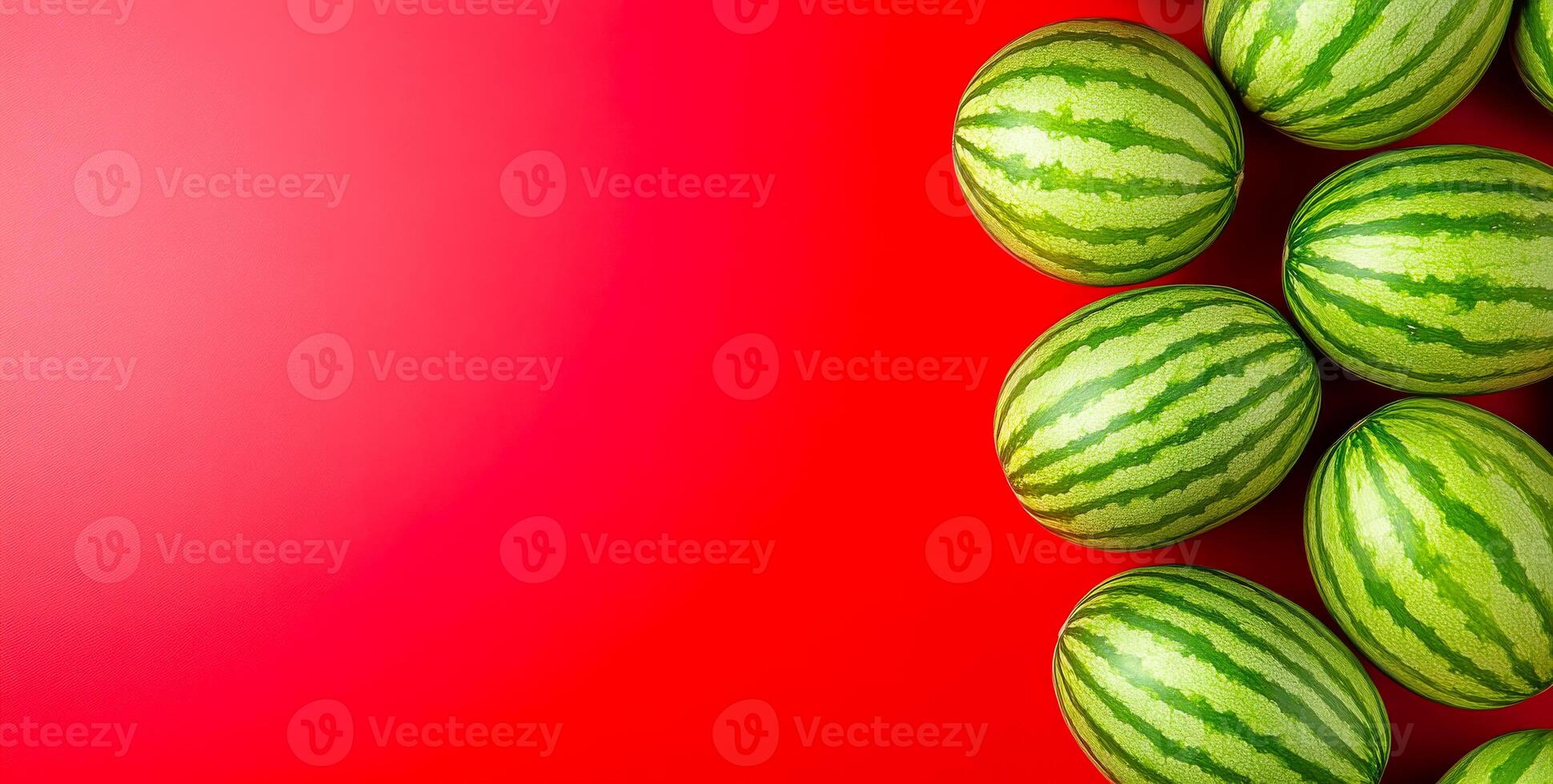 Watermelons on bright backdrop. A colorful arrangement of several fresh watermelons on a bright red surface creates a striking contrast. photo