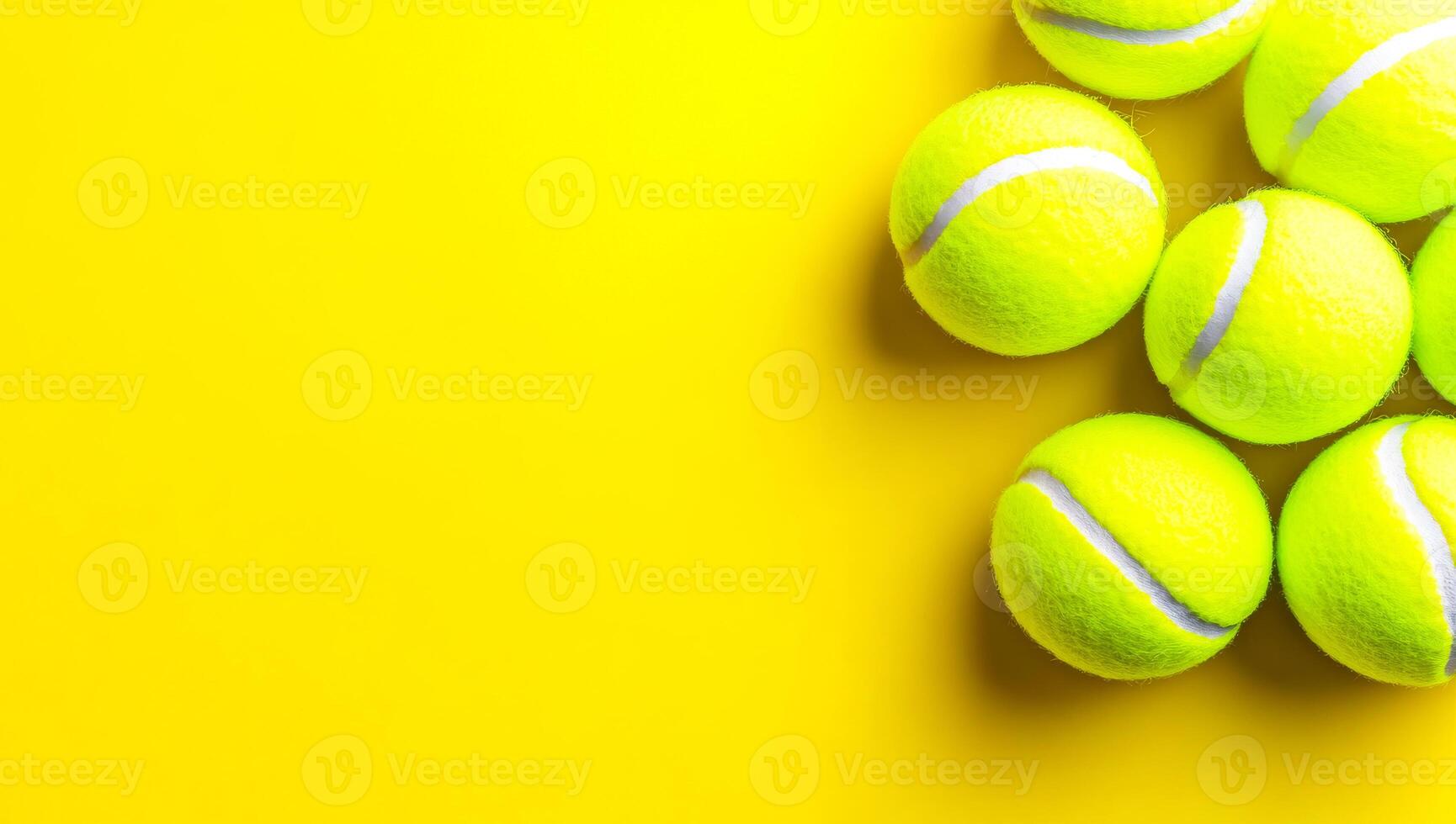 Neatly arranged yellow tennis balls. Vibrant yellow tennis balls are clustered together on a vivid yellow background, highlighting their texture and color. photo