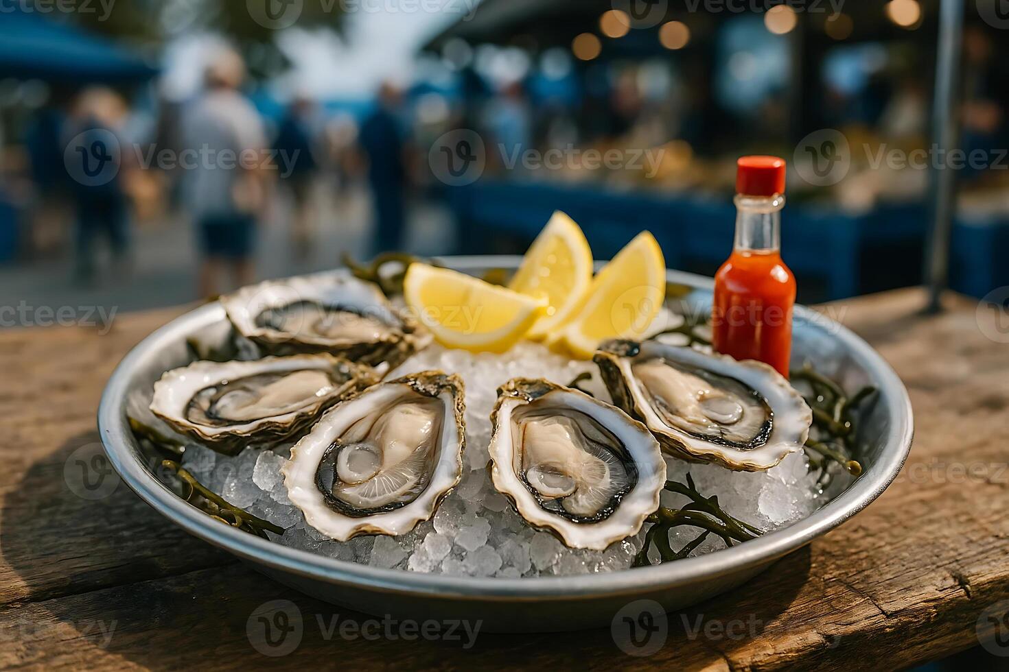 Oysters on ice with lemon and a bottle of hot sauce photo