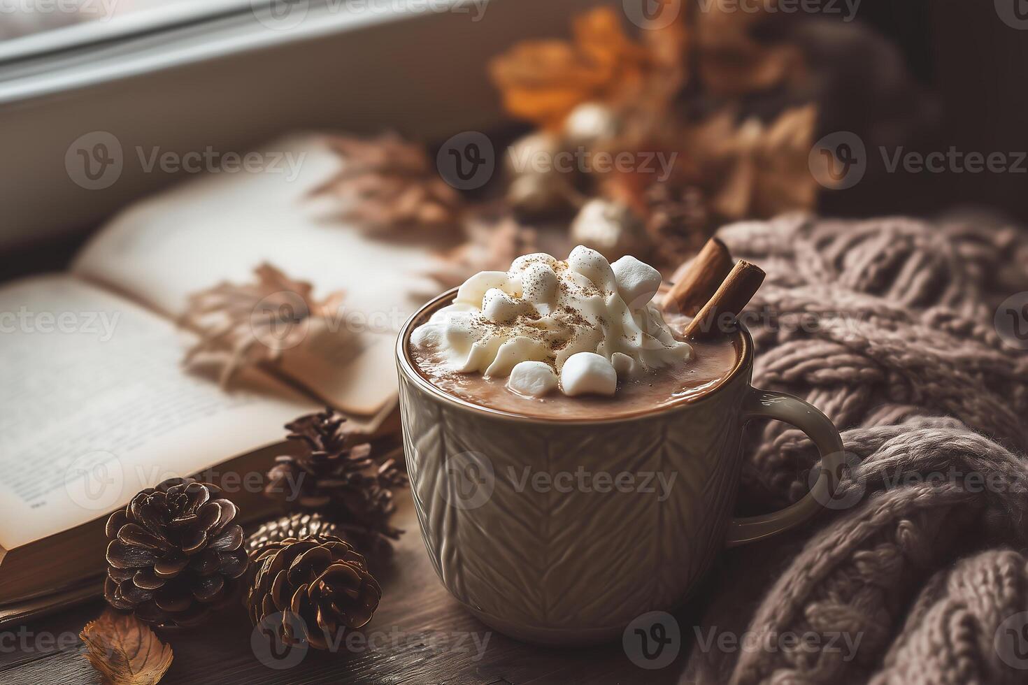 Hot chocolate with marshmallows and cinnamon on a window sill photo