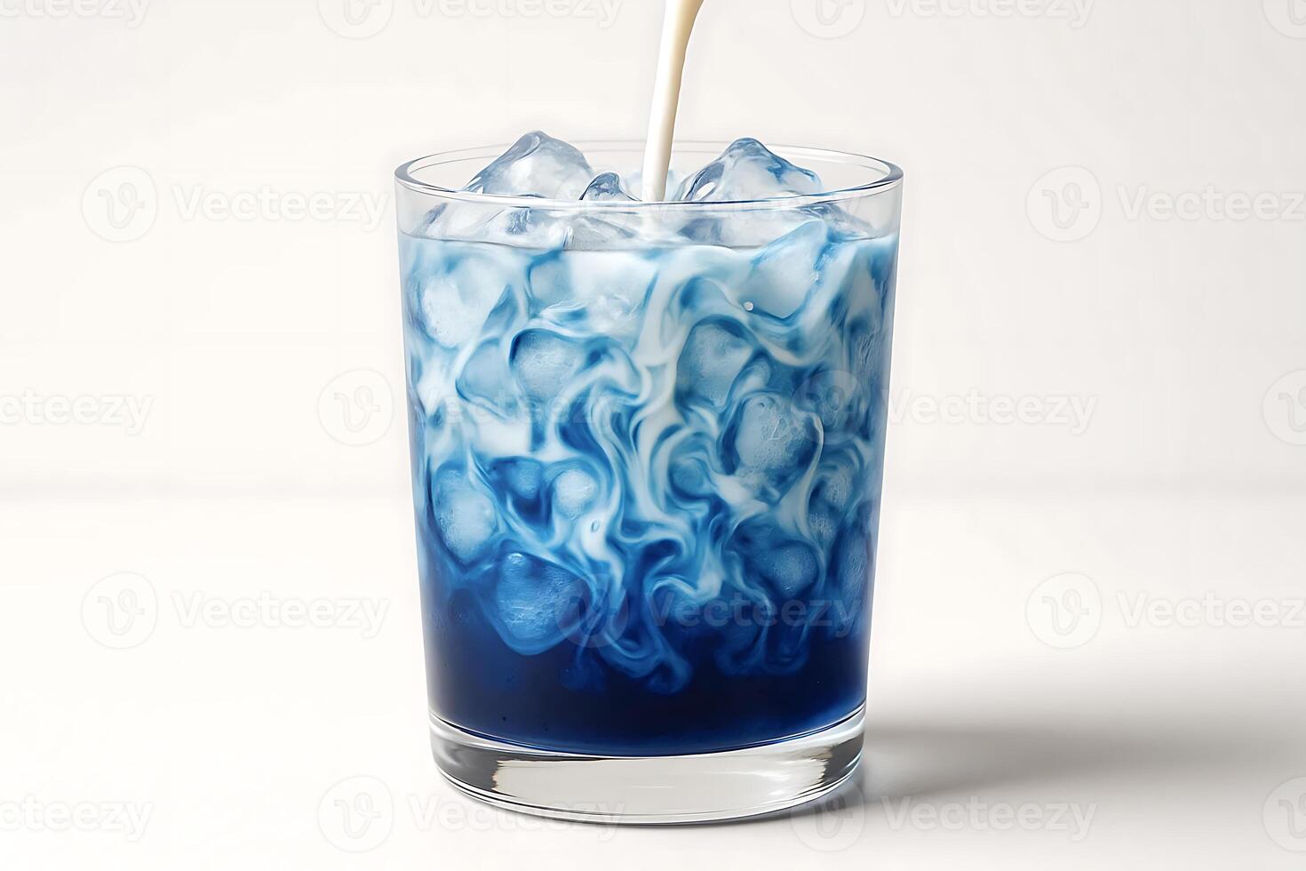 Blue milk being poured into a glass of ice photo