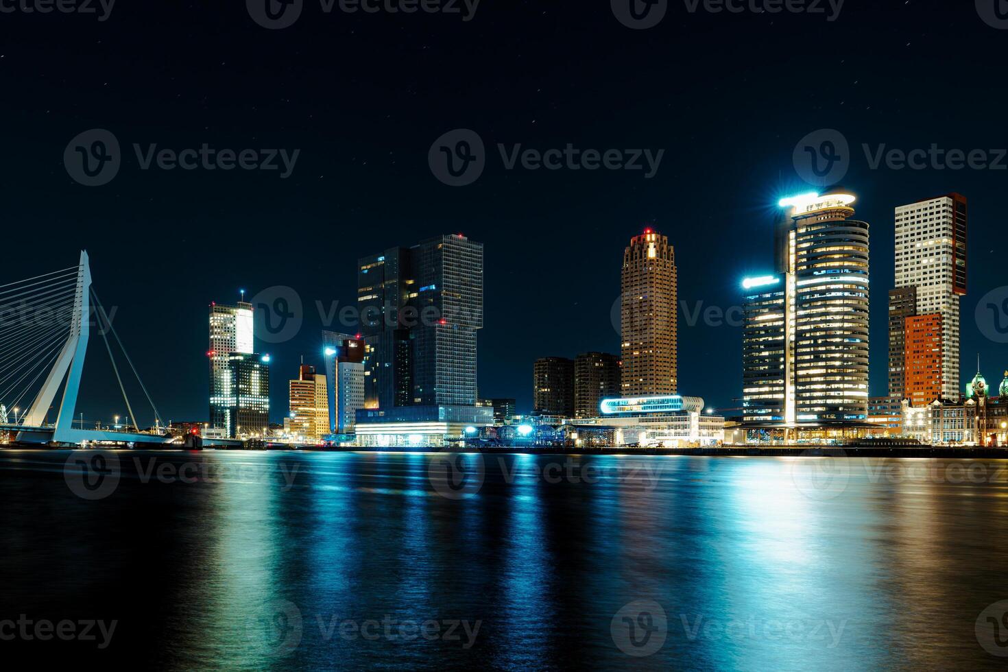 A mesmerizing night panorama of the city of Rotterdam, showcasing its modern high-rise architecture against a backdrop of a starry night sky, creating an enchanting and captivating urban landscape. photo