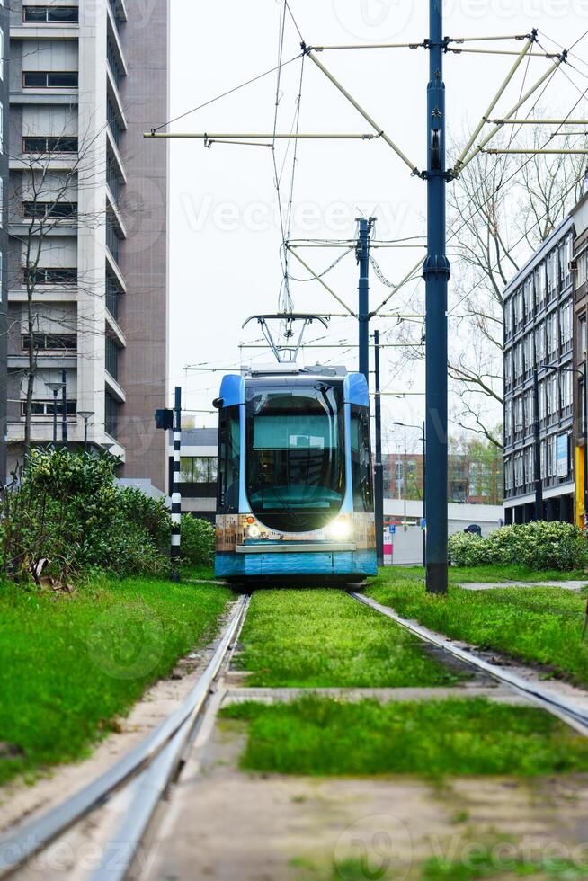Discover the modern urban landscape of Rotterdam with its electric trams, a sustainable and convenient public transit system that enhances the city's mobility. photo