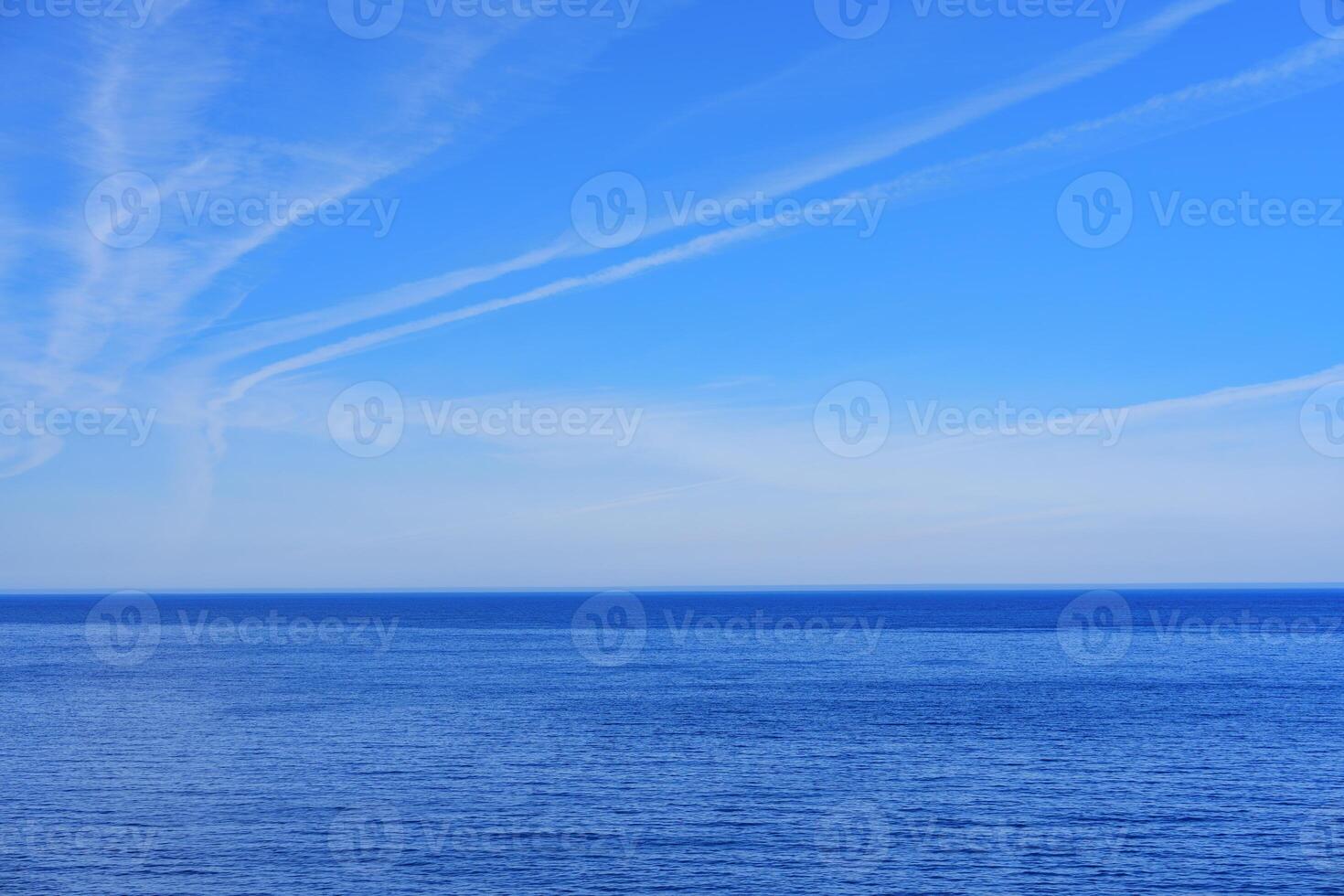Tranquil seascape with a clear blue sky stretching to the horizon, perfect for promotional advertisements and travel brochures. The serene scene evokes a sense of peace and relaxation. photo
