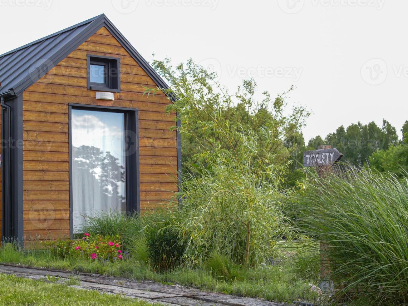 Small wooden house with a window and a sign that says The Farm photo