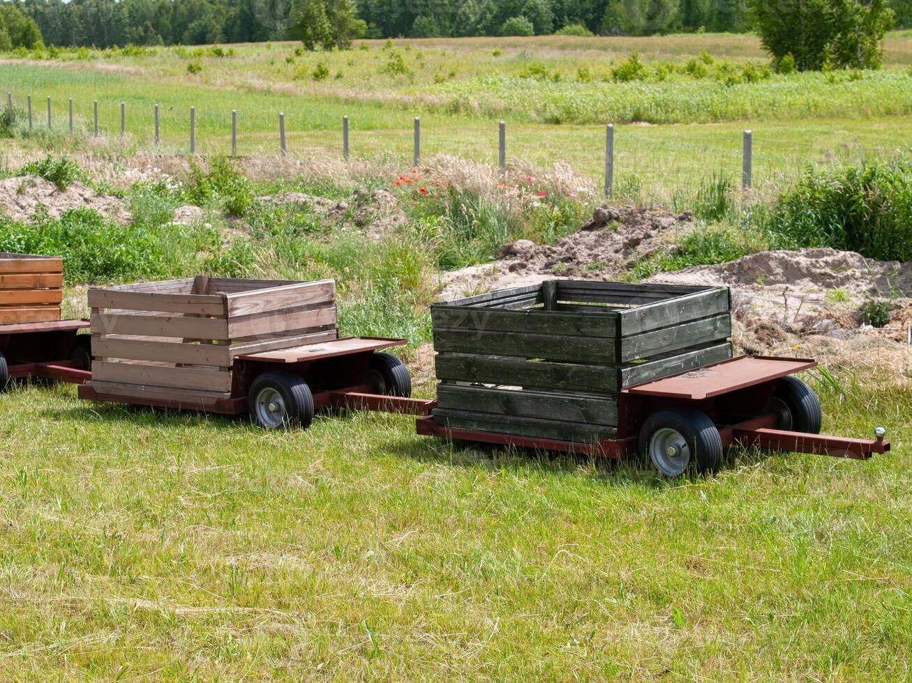 Two wooden crates are sitting in a field photo
