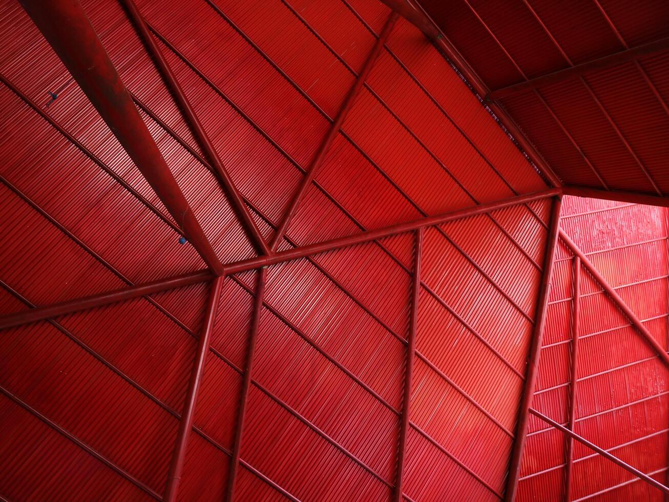 Bottom view rustic steel roof in red color geometric background for aesthetic modern minimalist retro concept photo