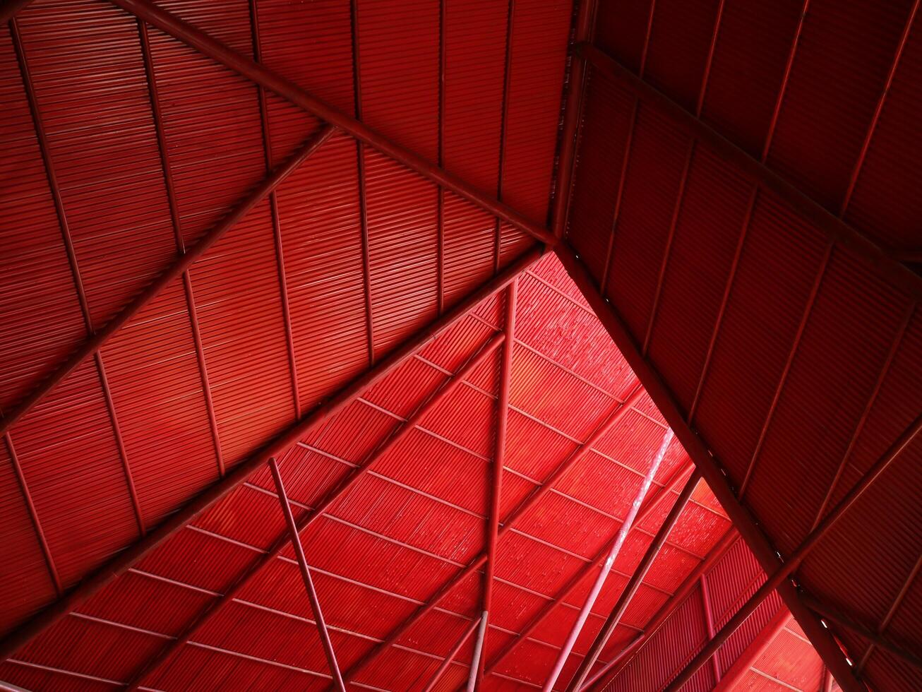Bottom view rustic steel roof in red color, geometric background for aesthetic, modern, minimalist conc photo