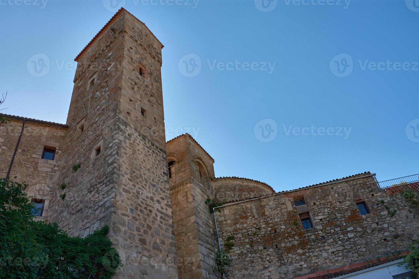 Defensive architecture of the Fortress of Luis de Chaves the Elder in Extremadura, highlighting its medieval watchtower against a serene sky photo