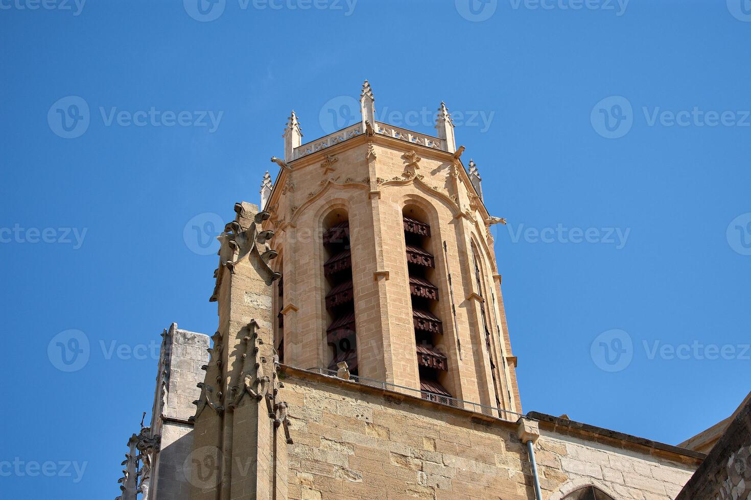 Decorative stone detail of the Town Hall tower in Aix en Provence with flags waving and clear architectural symmetry photo