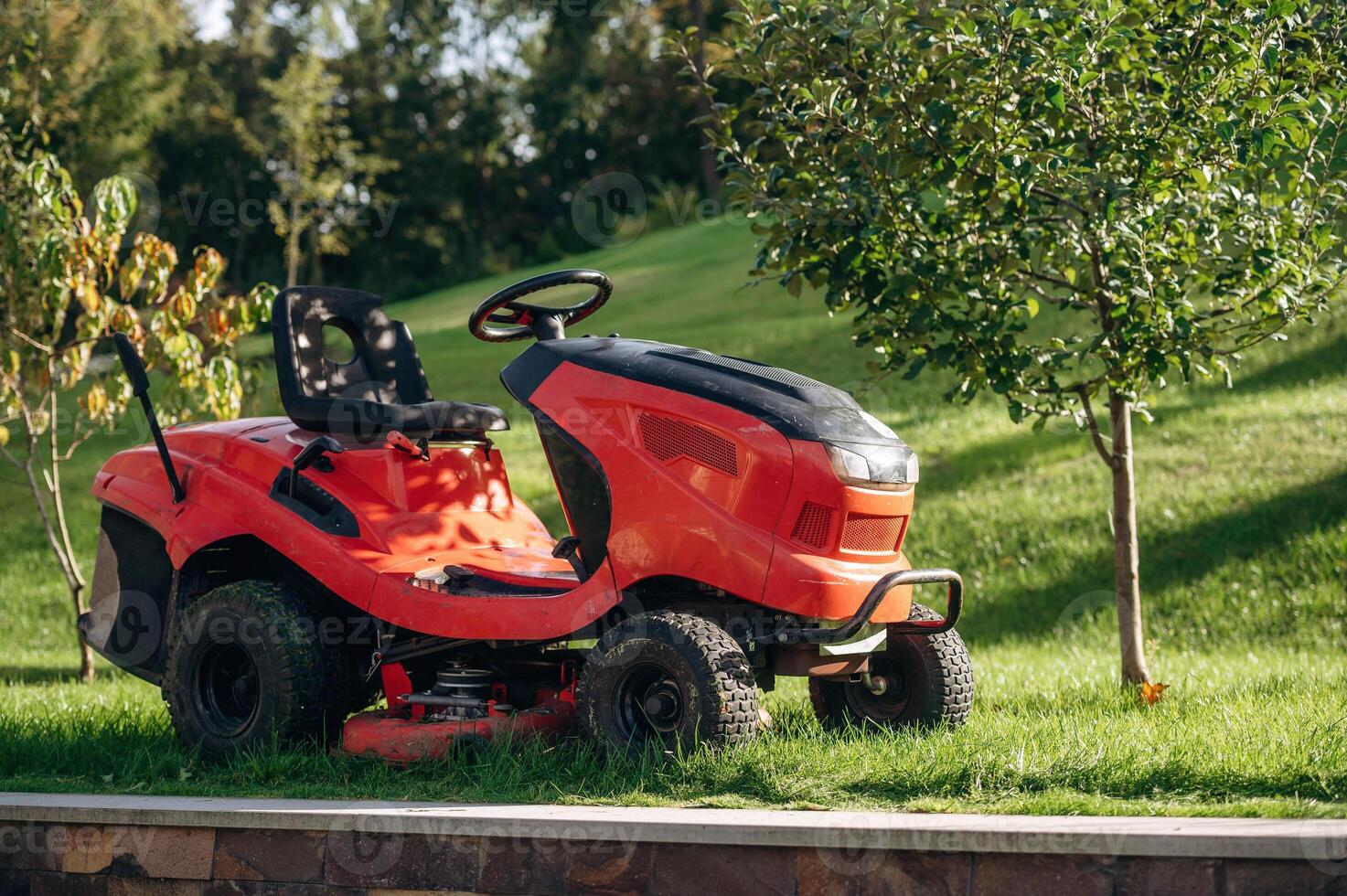 Lawn ,mover, is on the green grass at daytime photo
