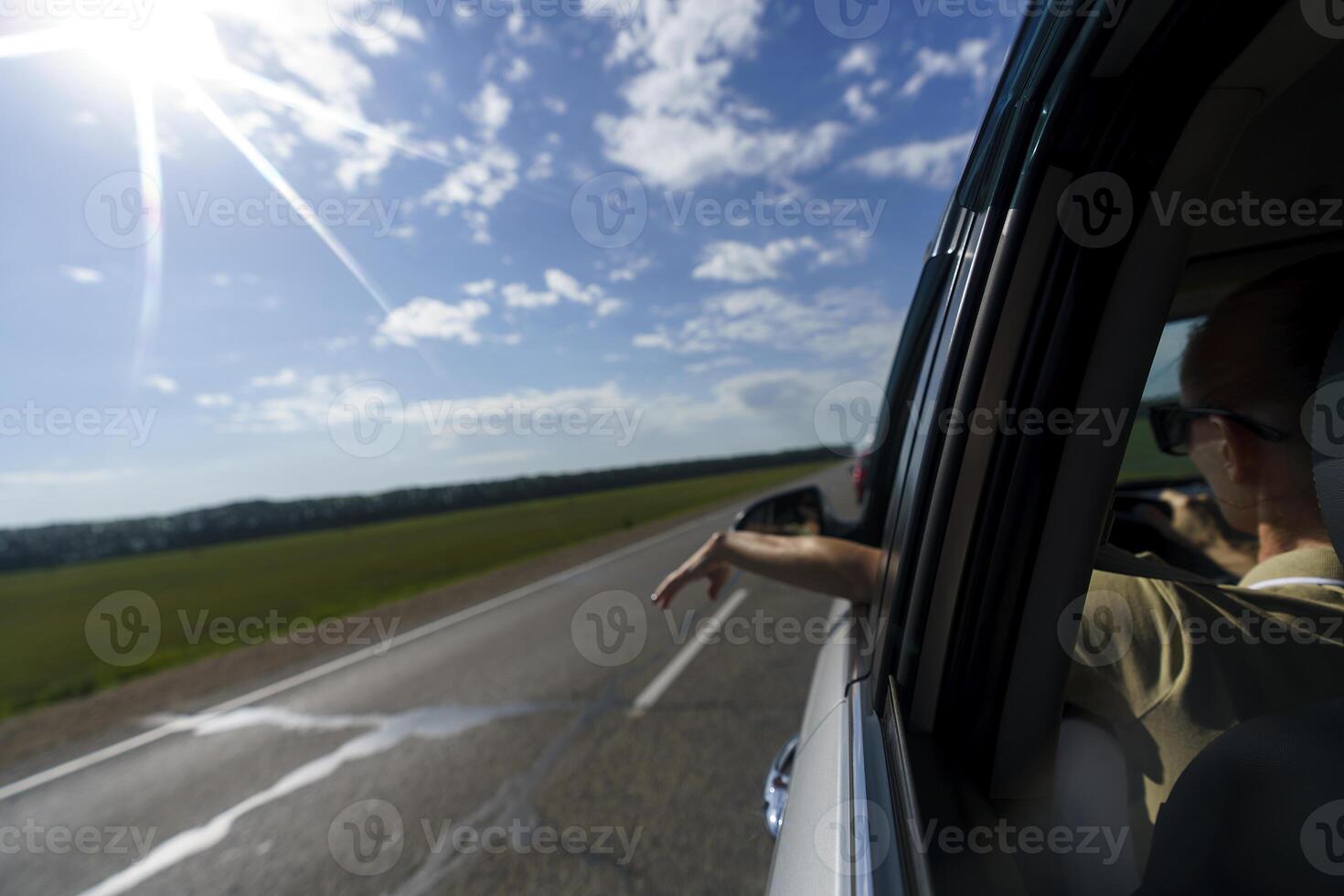 woman travels by car, on the roads with mountains flashing outside the window photo