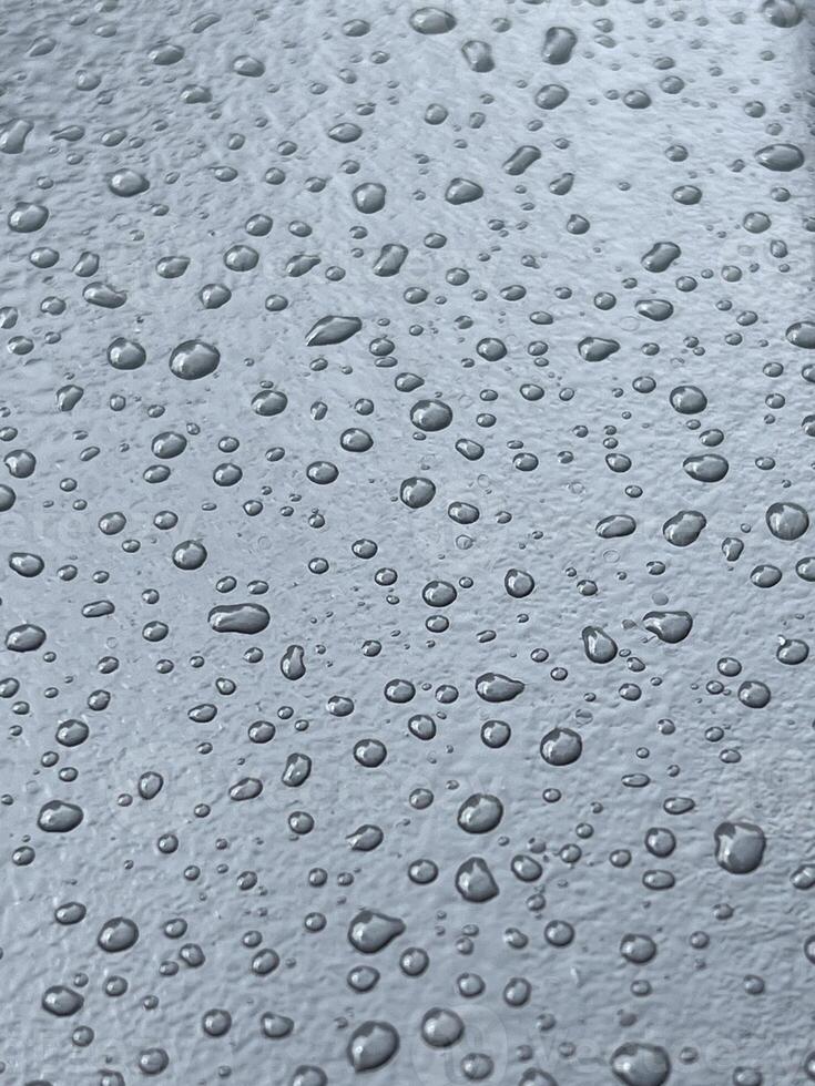 large transparent shiny raindrops fell on a smooth surface, background photo