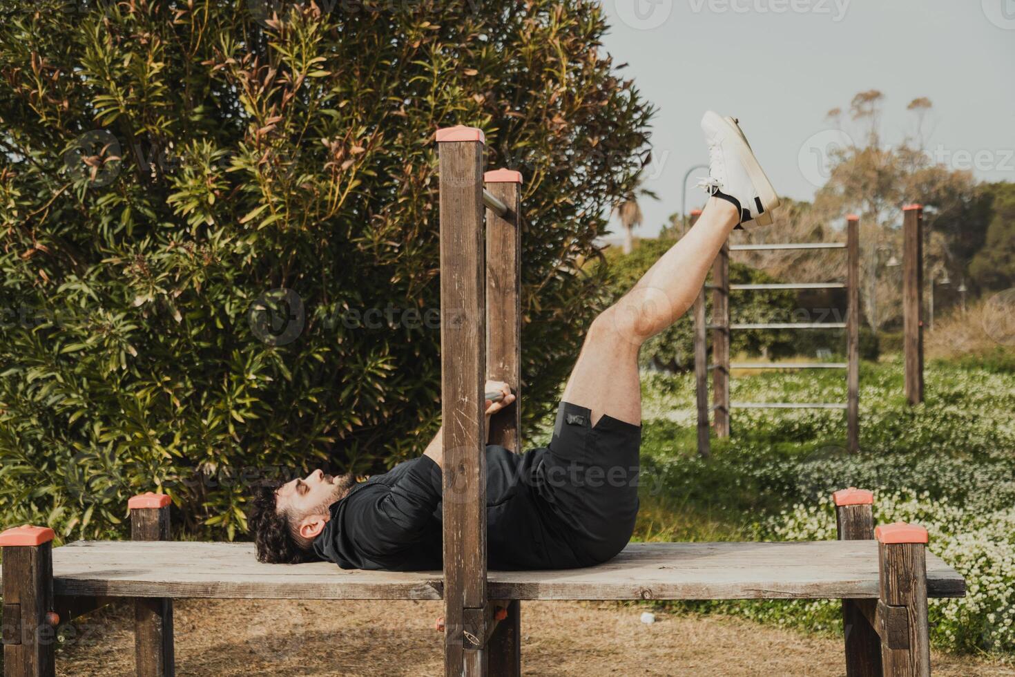Man Does Intense Exercise Using City Park Structures photo