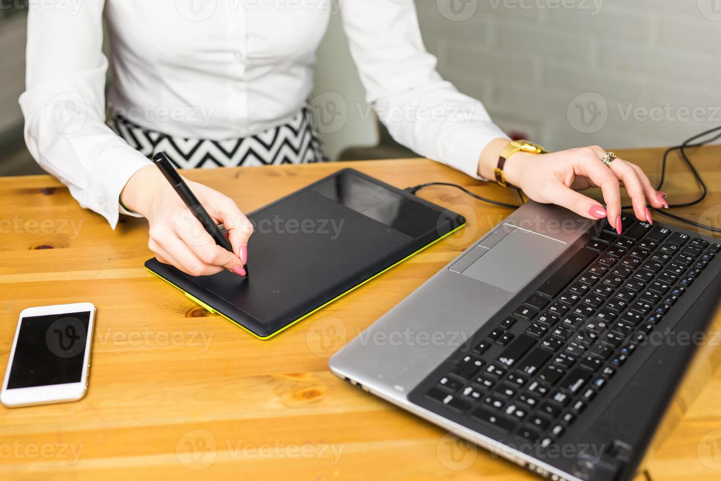 Woman hand drawing with graphics tablet, working designer close-up photo