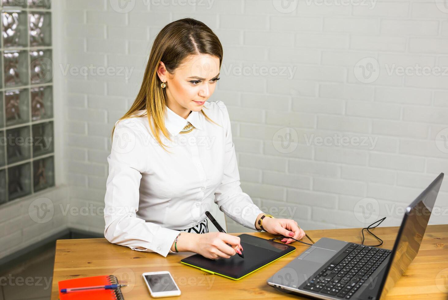 artist drawing something on graphic tablet at the office photo