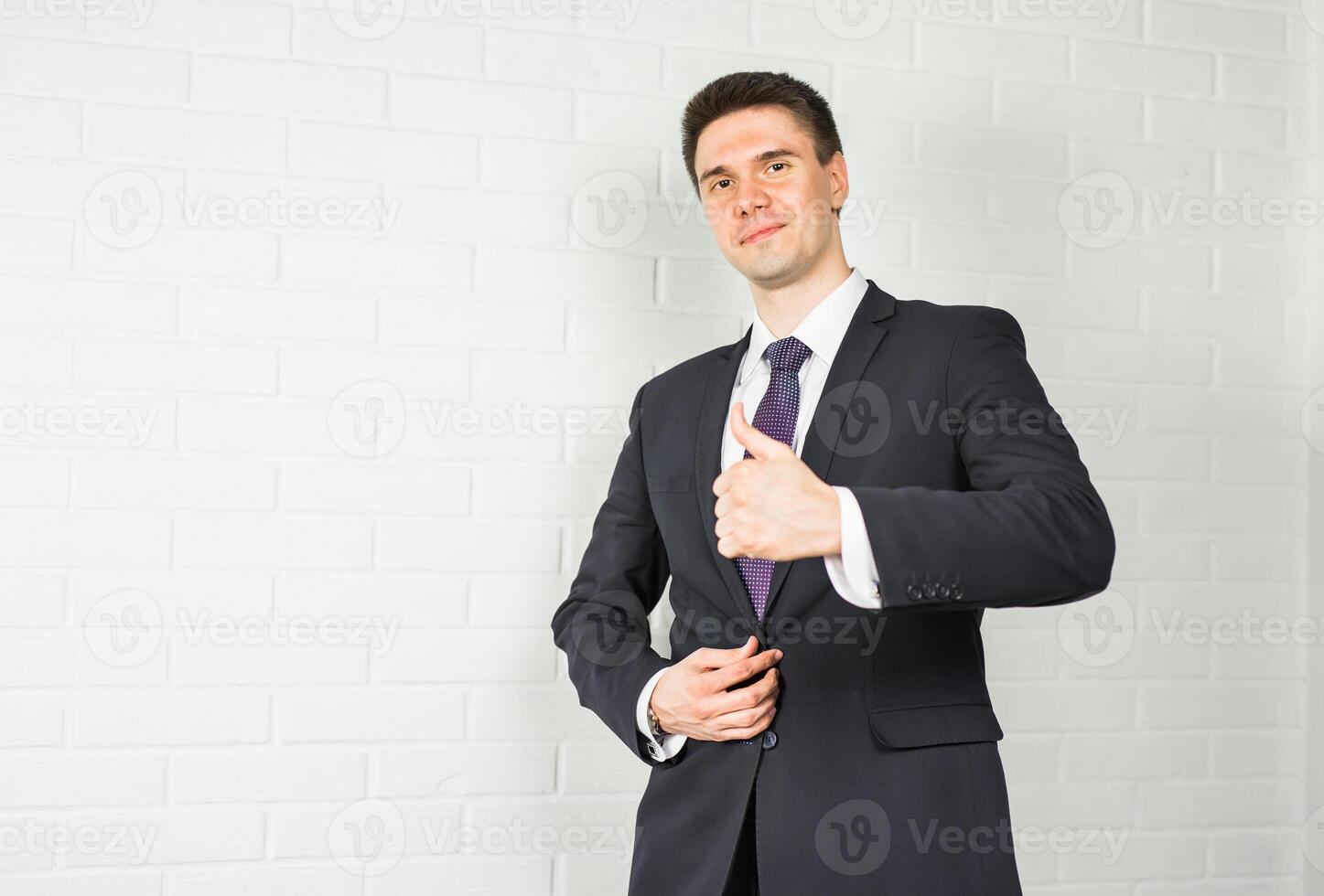 Businessman showing OK sign with his thumb up. photo