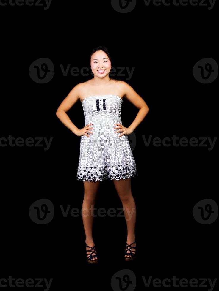 Smiling Japanese American Woman Standing Arms Akimbo In Dress photo