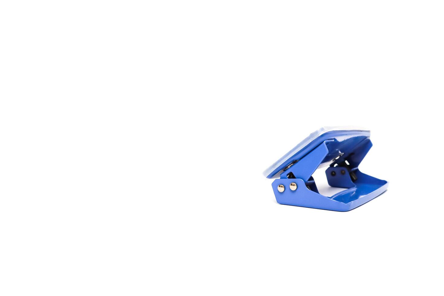 A Single Blue Hole Punch Isolated on White Background in a Studio Shot, Perfect for Stationery Product Mockups and Design Assets photo