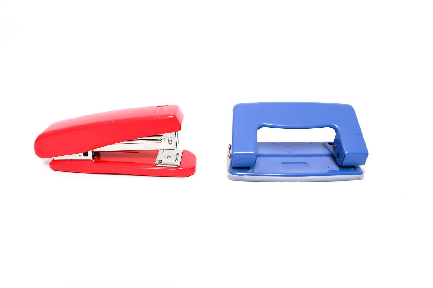 Vibrant Red Stapler and Blue Hole Puncher on a Clean White Backdrop photo