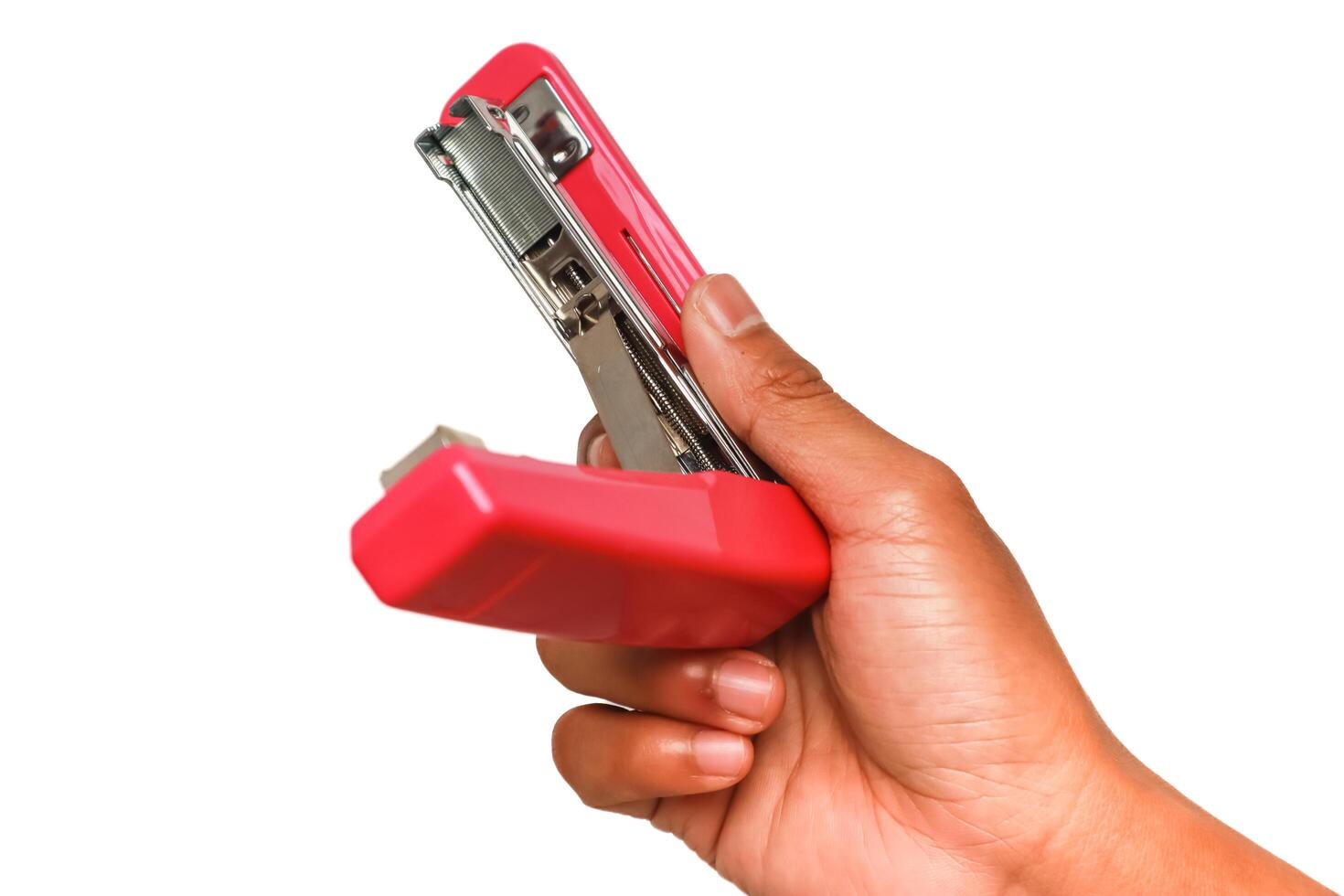 Hand Holding a Red Stapler Ready to Use for Paper Fastening Task in Office photo
