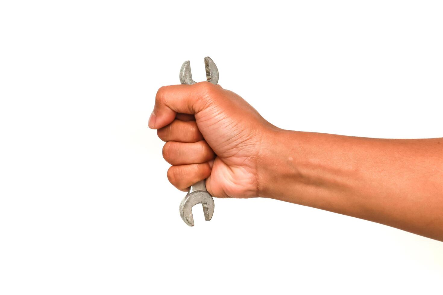 Hand firmly holding a wrench against a clean white background photo