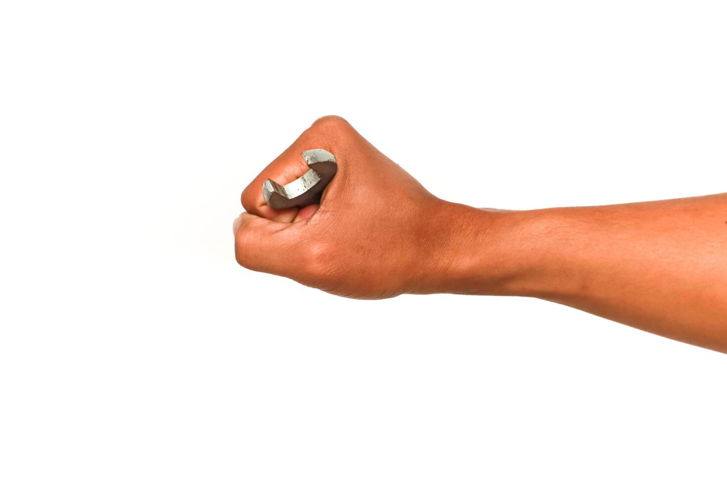Close-up of a clenched fist holding a crescent wrench against a white background photo