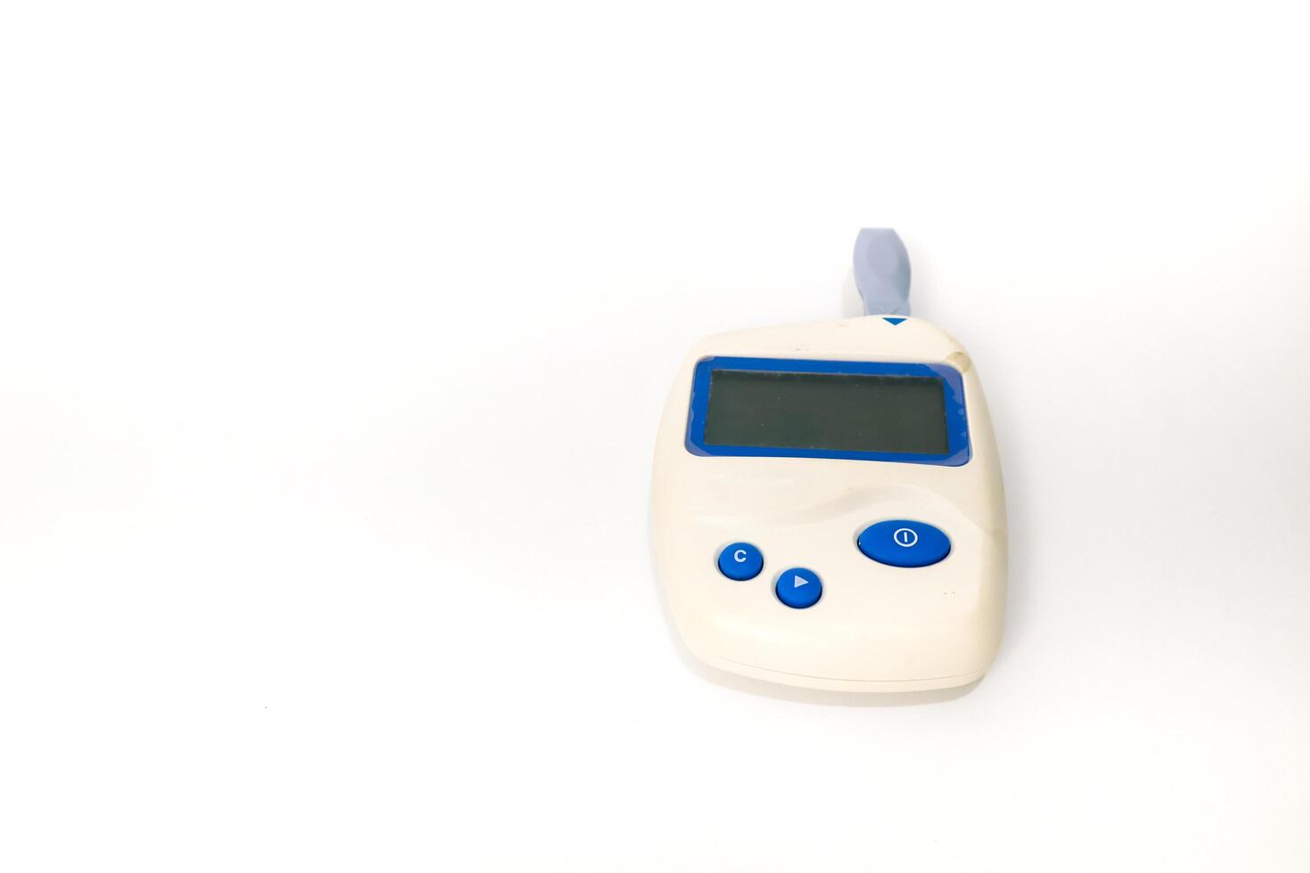 Close-up studio shot of a portable blood glucose meter on a white background, for diabetes monitoring and healthcare photo