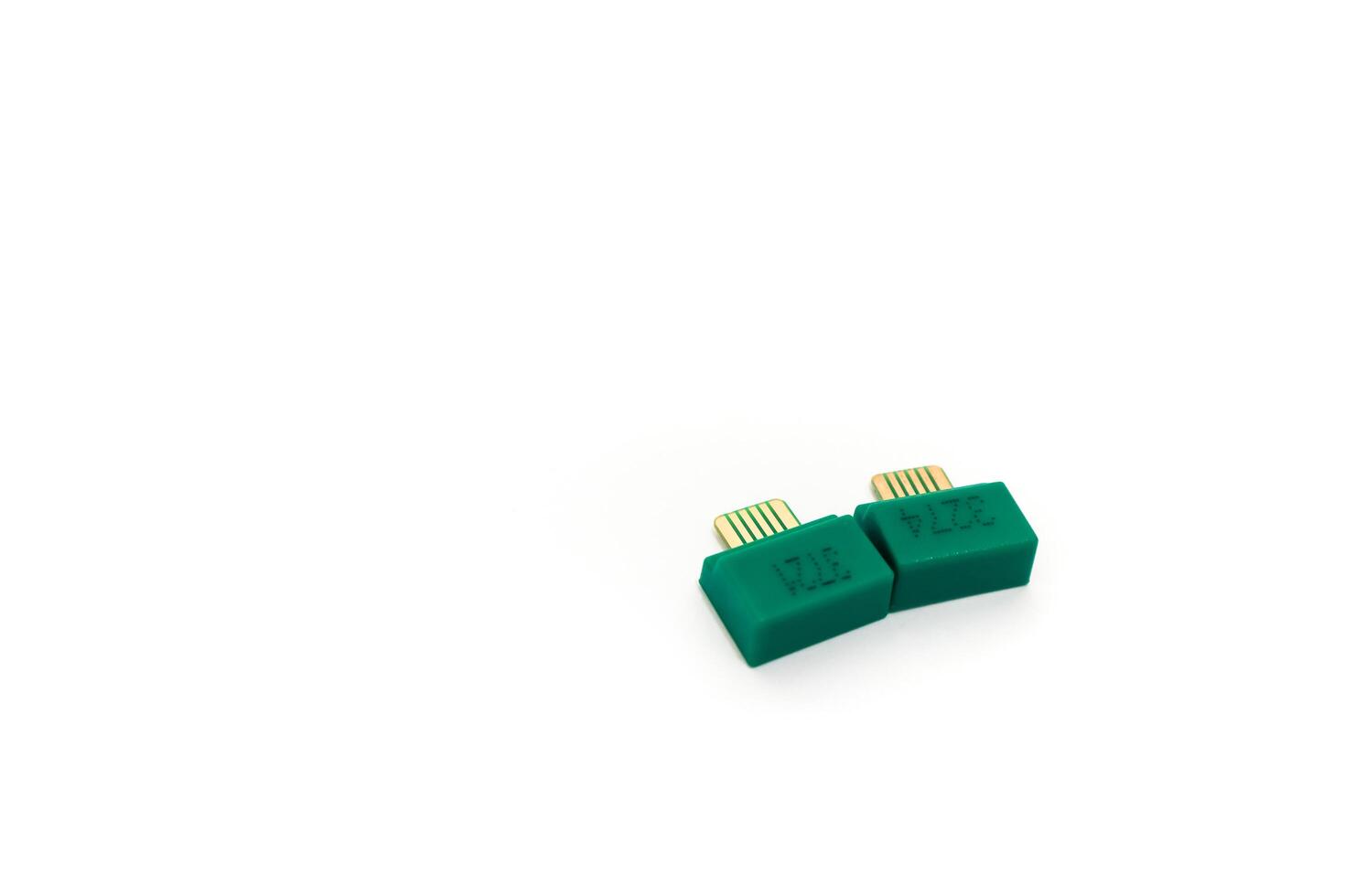 Close-up of two green computer connectors on a white background in high definition photo