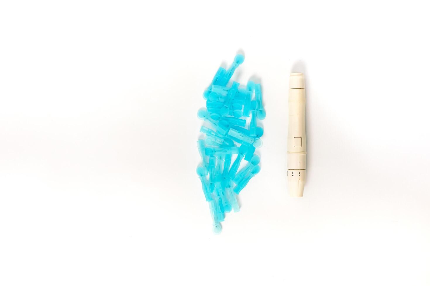 Close-up of lancets and lancing device for blood glucose monitoring, health concept photo