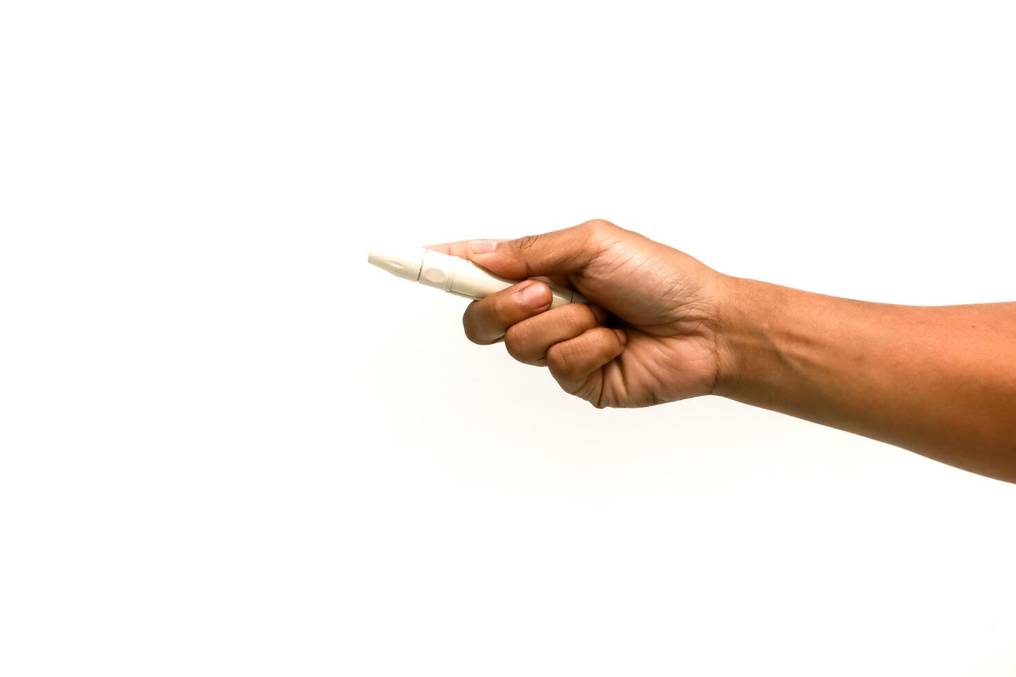 A close-up of a hand holding a white chalk isolated on a white background, perfect for educational or artistic themes photo