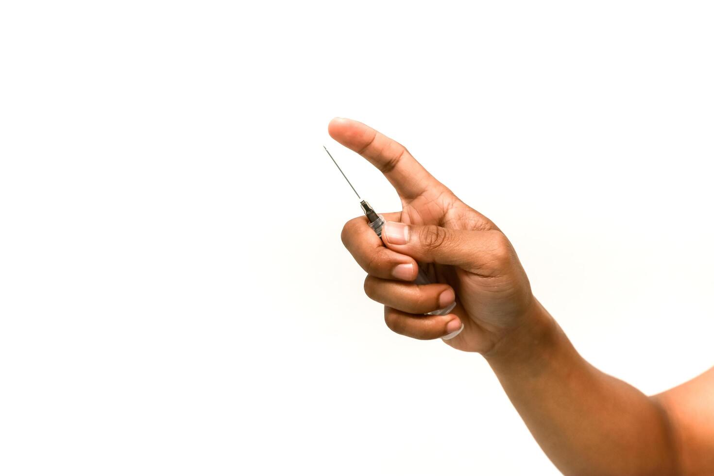 Close-up of a hand holding a lancet for a blood glucose test on a white background photo
