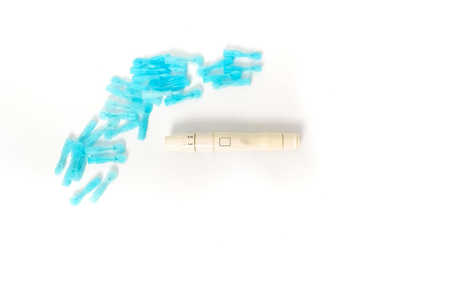 Glucose monitoring kit featuring lancets and a lancing device on a clean white background highlighting diabetes healthcare photo