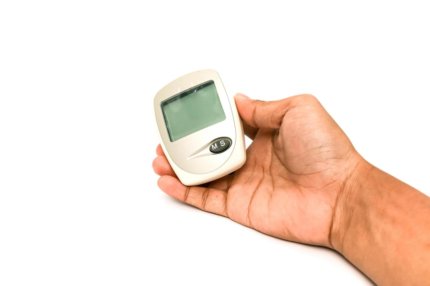 Hand Holding a Glucose Meter for Diabetes Monitoring on a White Background photo