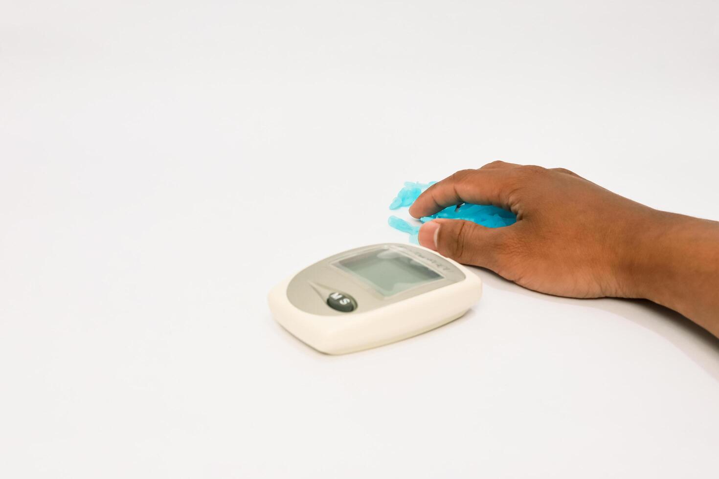 Blood glucose meter with finger device illustrating diabetes testing procedure photo