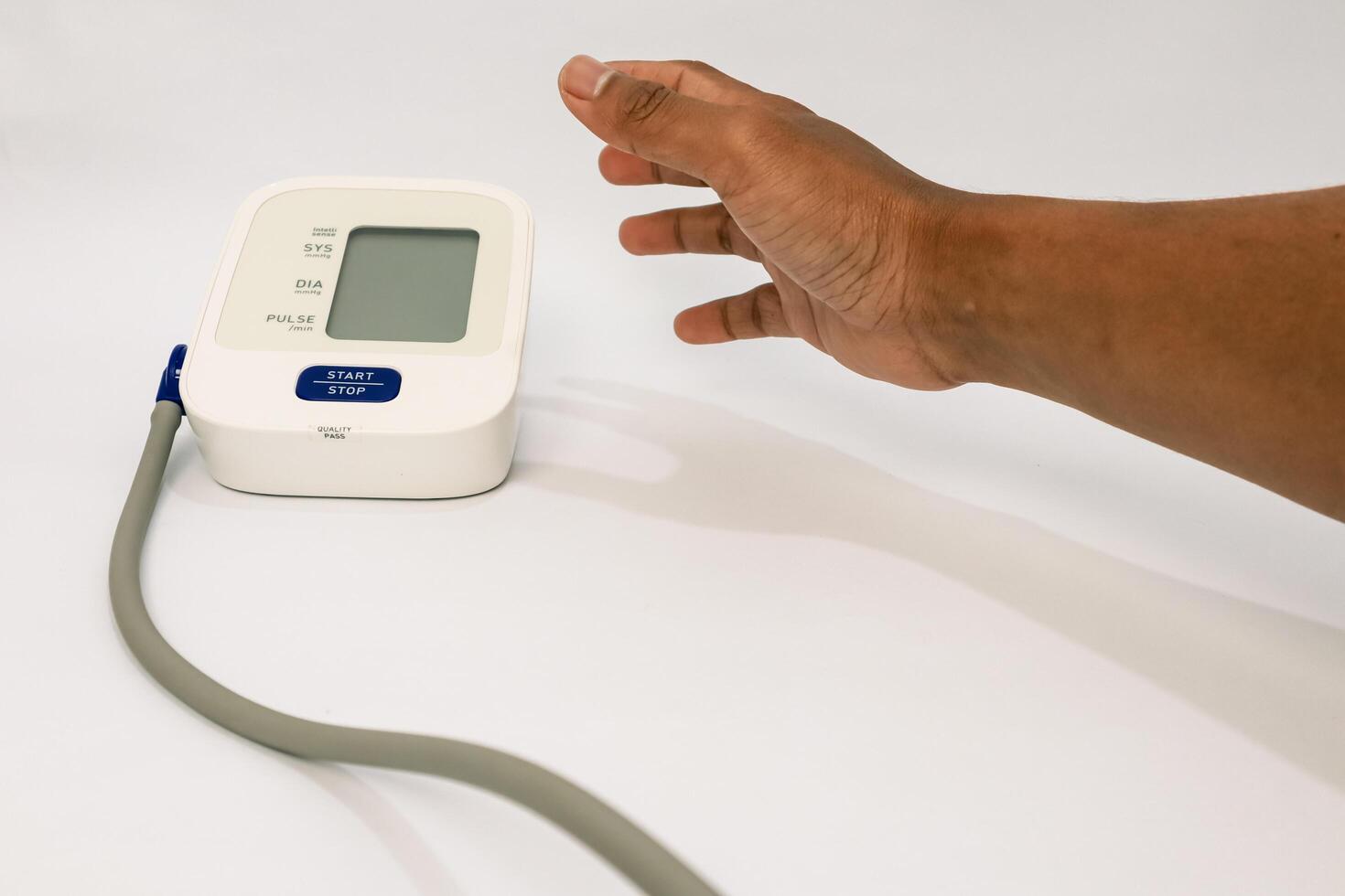 Blood pressure measurement with digital tonometer and dark-skinned human hand photo