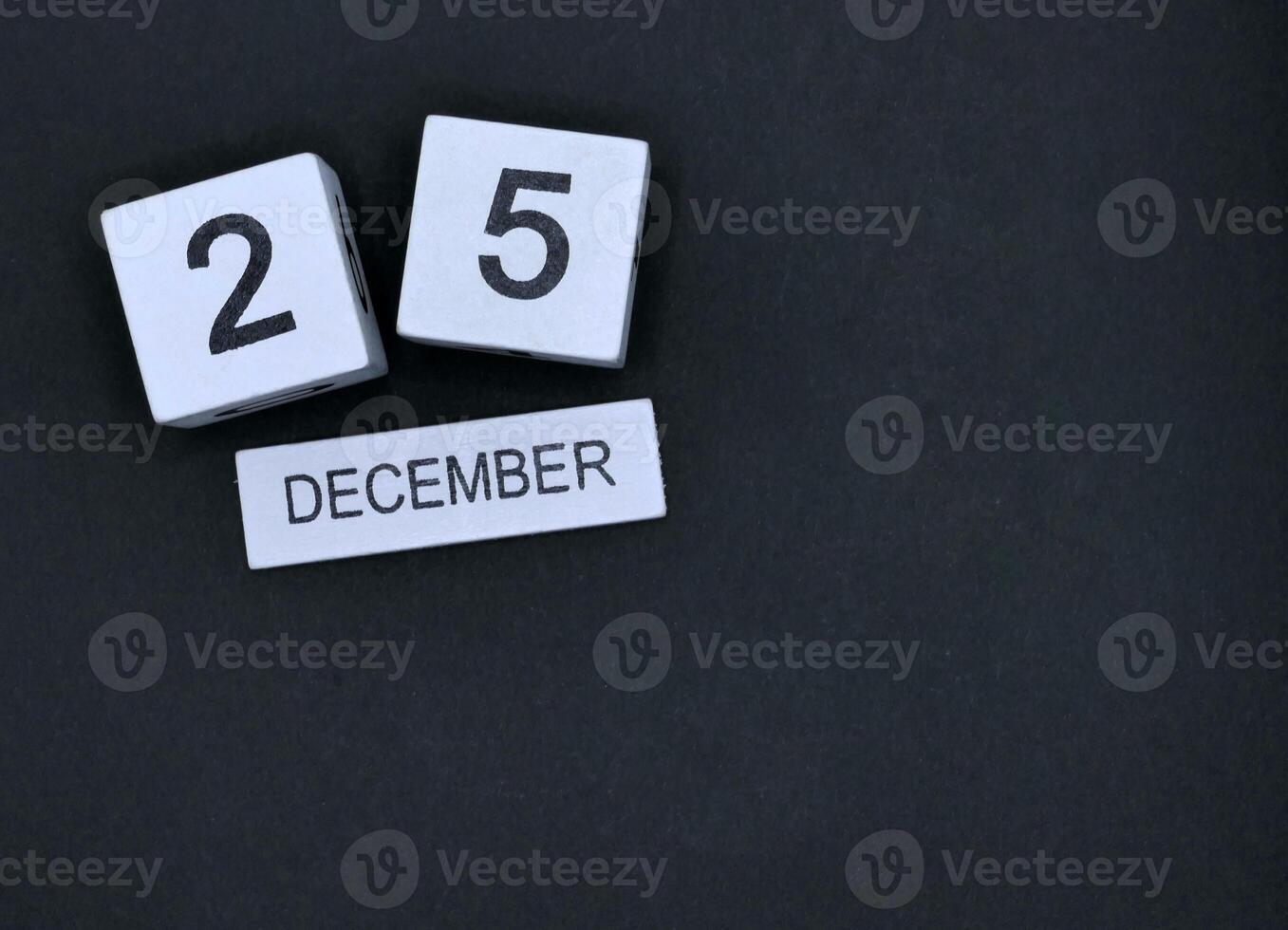 Calendar wood block December 25th Christmas Day on black background photo