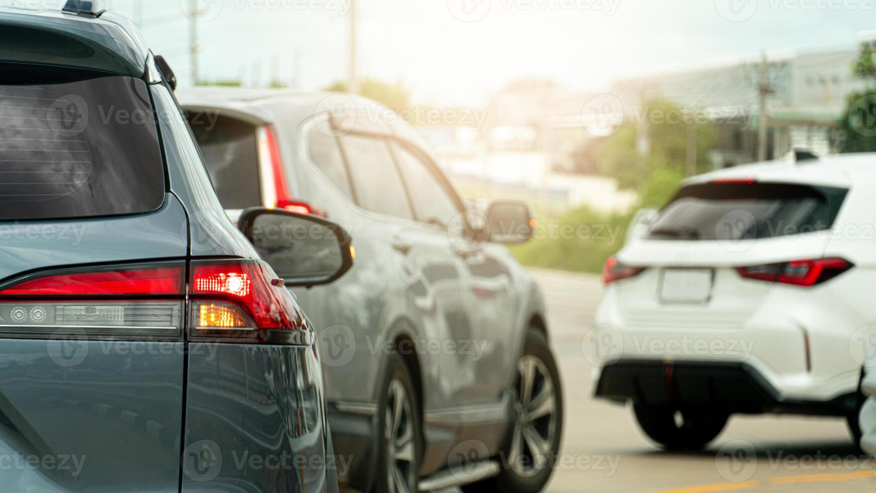 Transportation of cars on the road. Open light brake waiting to The front cars make a U-turn. Heading to travel or work. On the asphalt road. Environment in the afternoon effect sunlight. photo