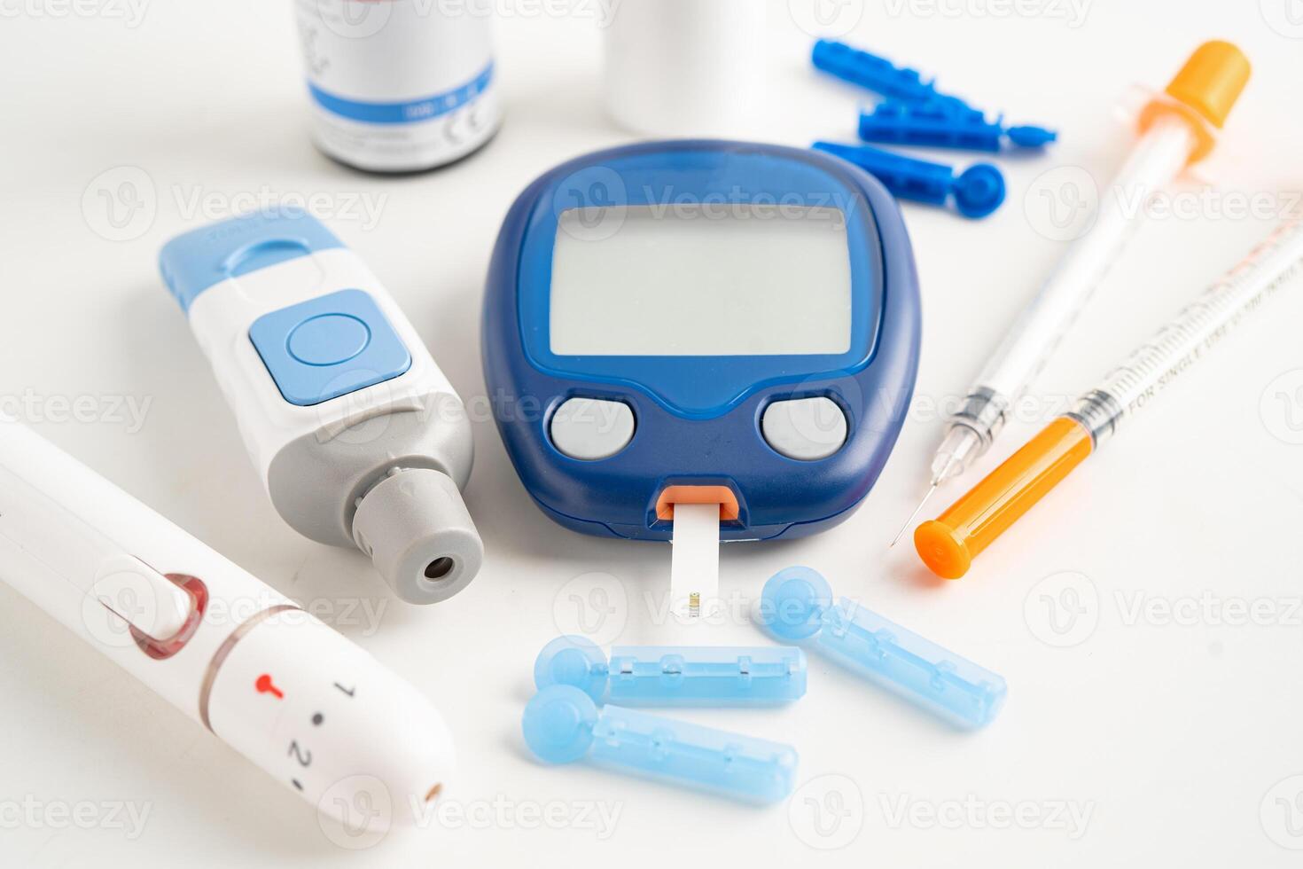 Glucometer lancet and test stick measuring human blood sugar level for diabetes. photo