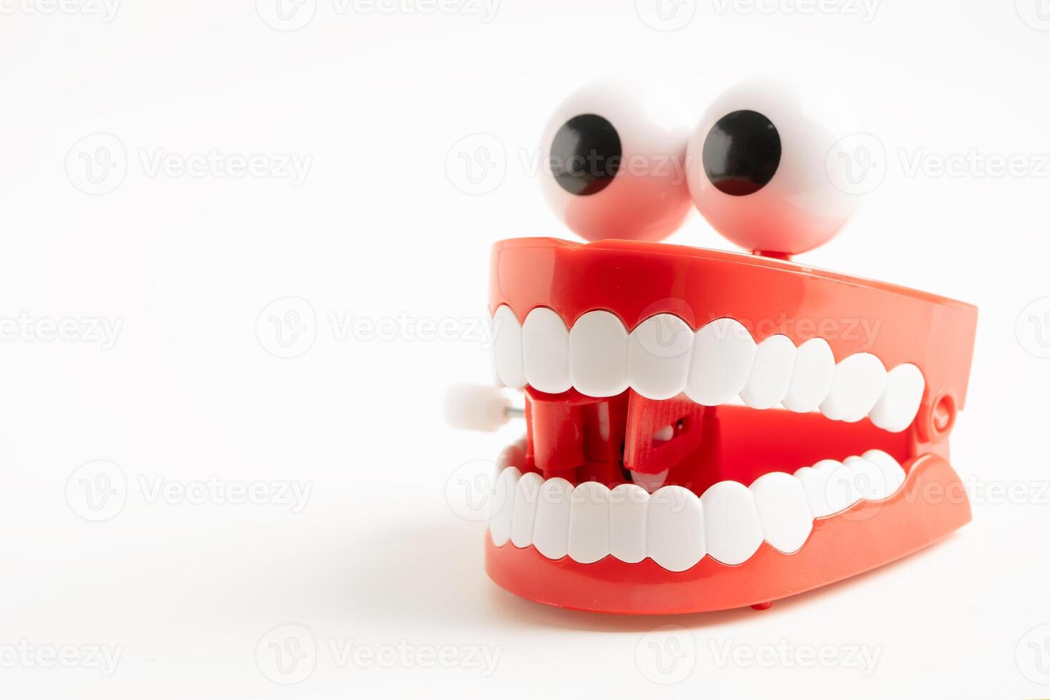 Tooth funny toy denture red color jaw and eye on white background photo