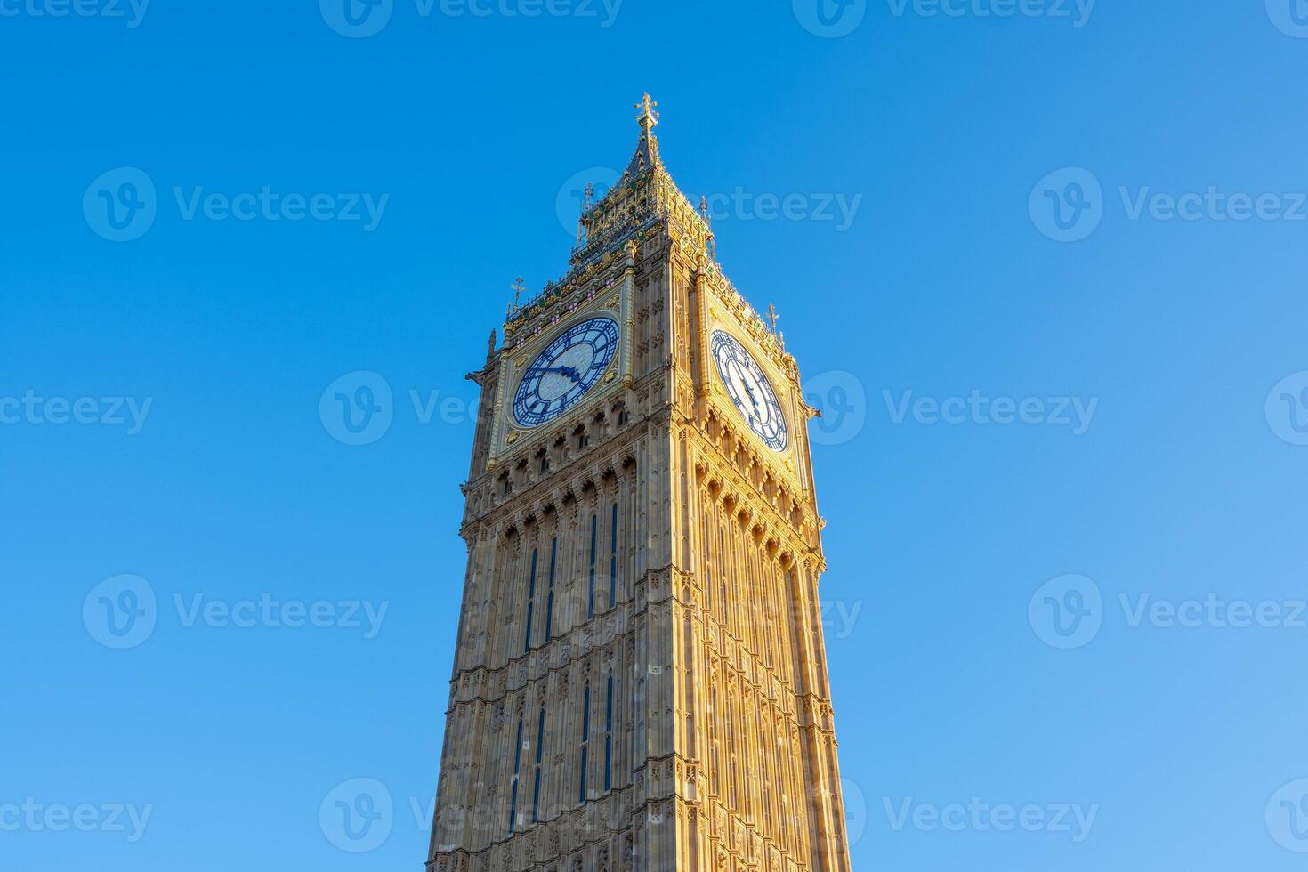 Big Ben stands tall against a vibrant blue sky in London, showcasing its intricate architecture. The clock tower is a symbol of British heritage and attracts many visitors. photo