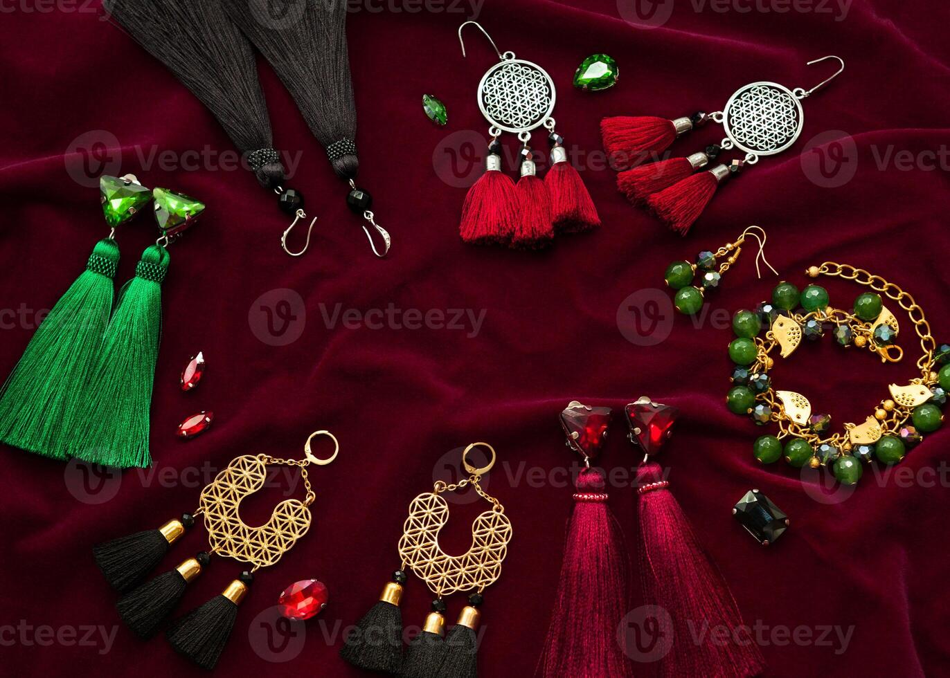 Handmade jewelry on the vinous velvet background photo