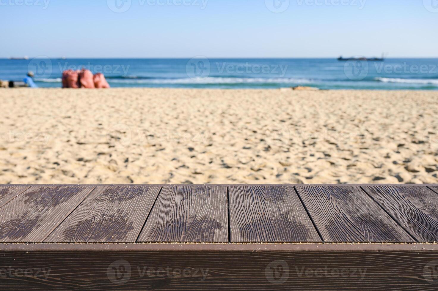Empty wood tabletop on the beach with blue sky photo