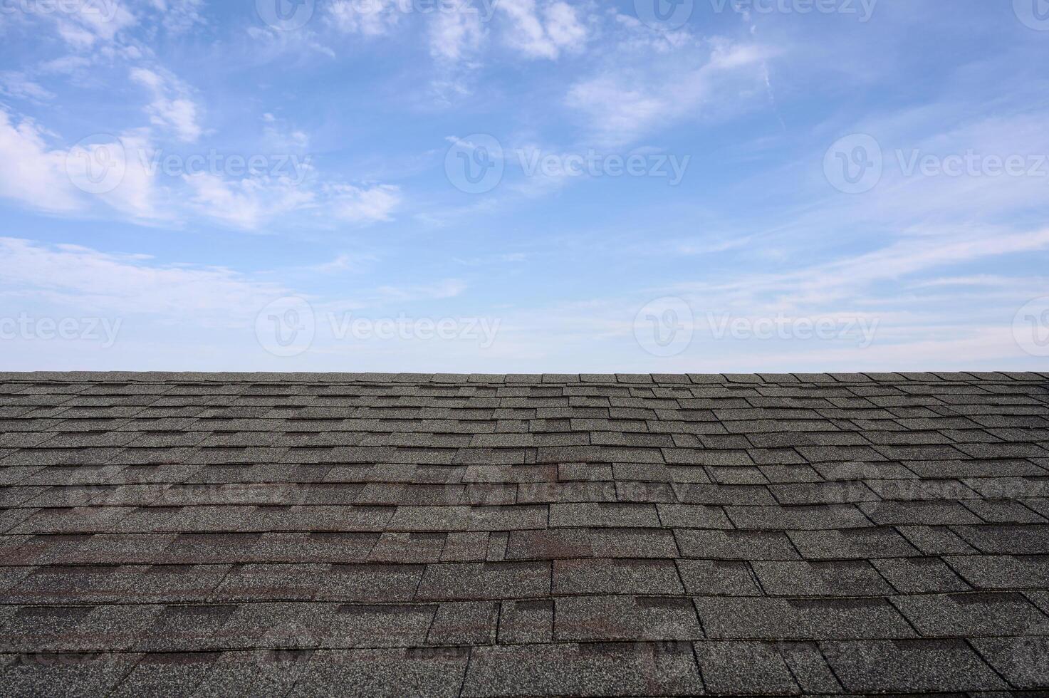Dark roof tiles with blue sky photo
